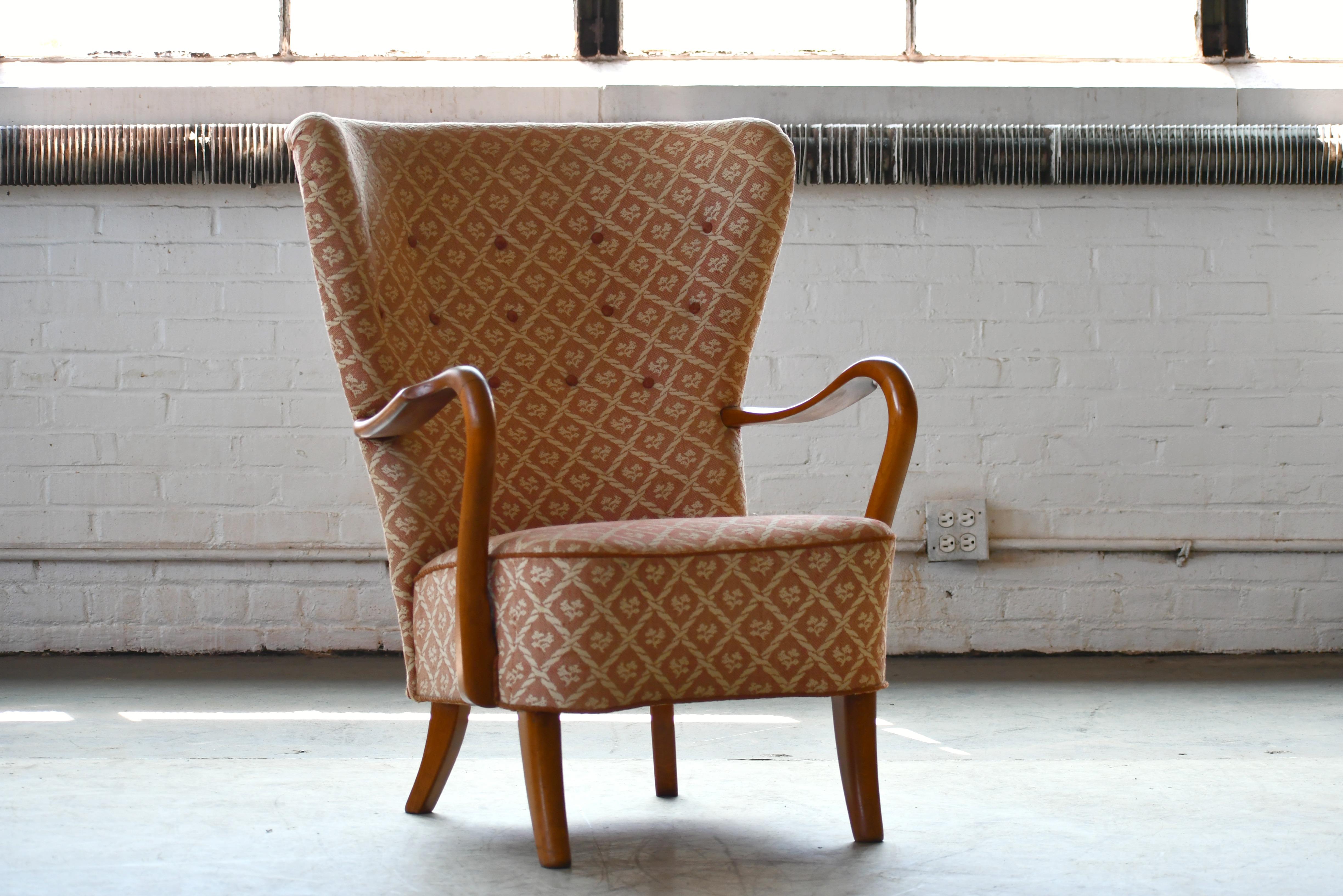 Classic elegant Danish high back armchair from the 1940s by Alfred Christensen for Slagelse Mobelvaerk with open armrests in beautifully curved elm wood. Nice slim elegant silhouette and very organic design lines. Solid and sturdy construction