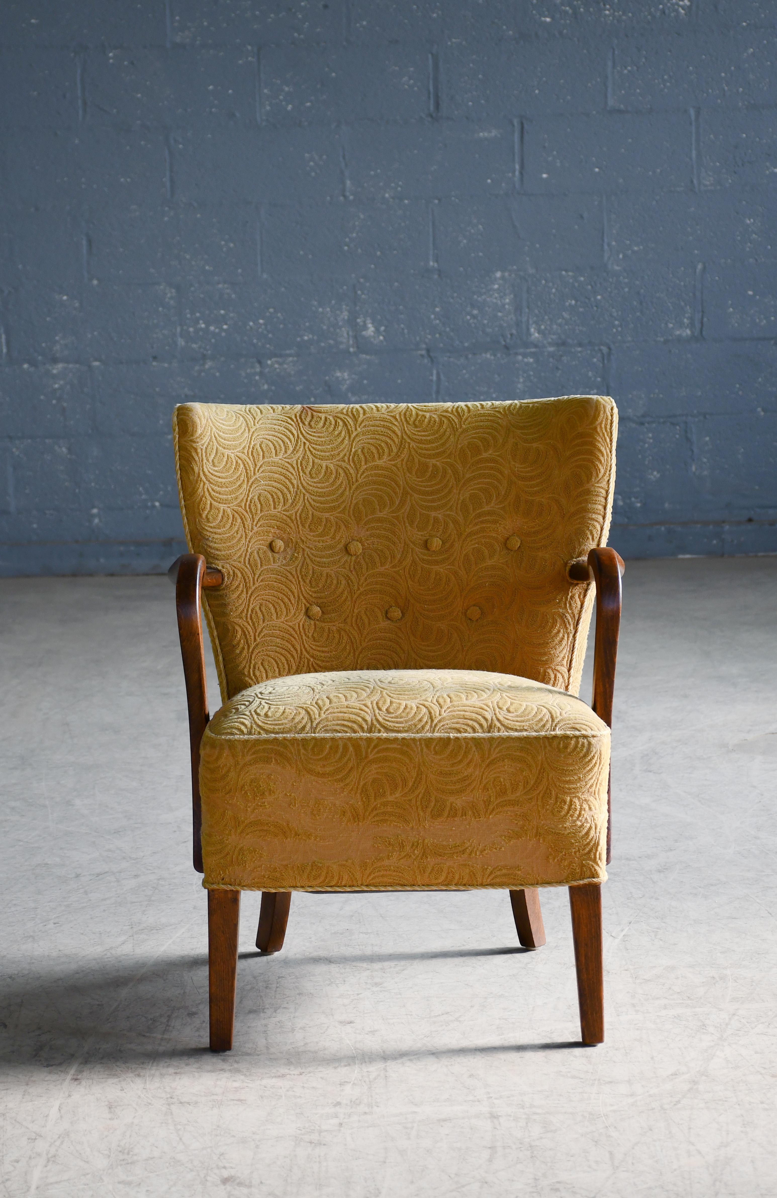Classic elegant Danish low back lounge chair from 1940s by Alfred Christensen for Slagelse Mobelvaerk with open armrests in beautifully curved stained beech. Nice slim elegant silhouette. Solid and sturdy construction and very comfortable. Alfred