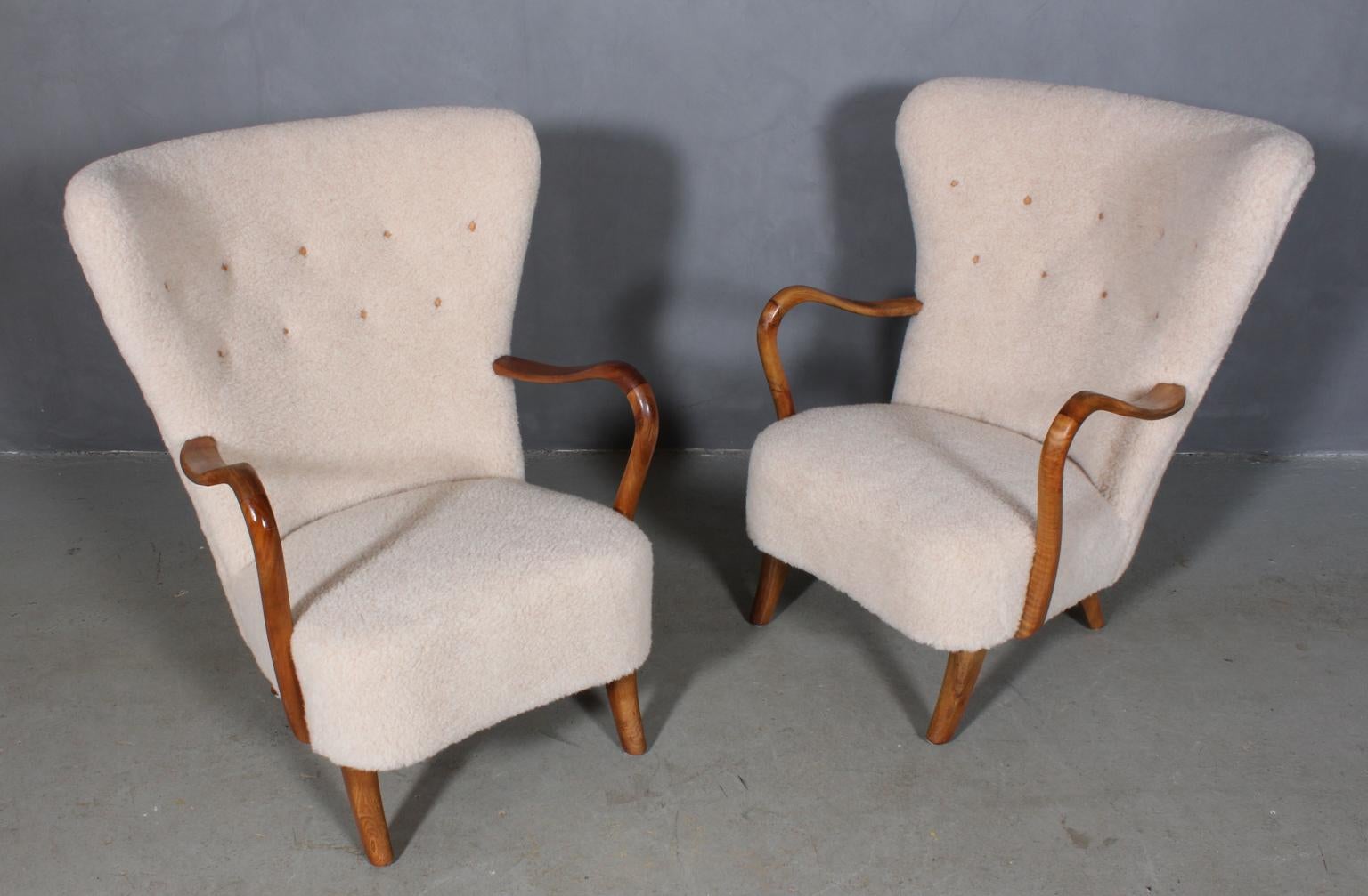 Alfred Christensen set of lounge chairs new upholstered with lamb wool and buttons of leather.

Legs and armrests of nut wood.

Made in the 1940s by Slagelse Møbelværk.

