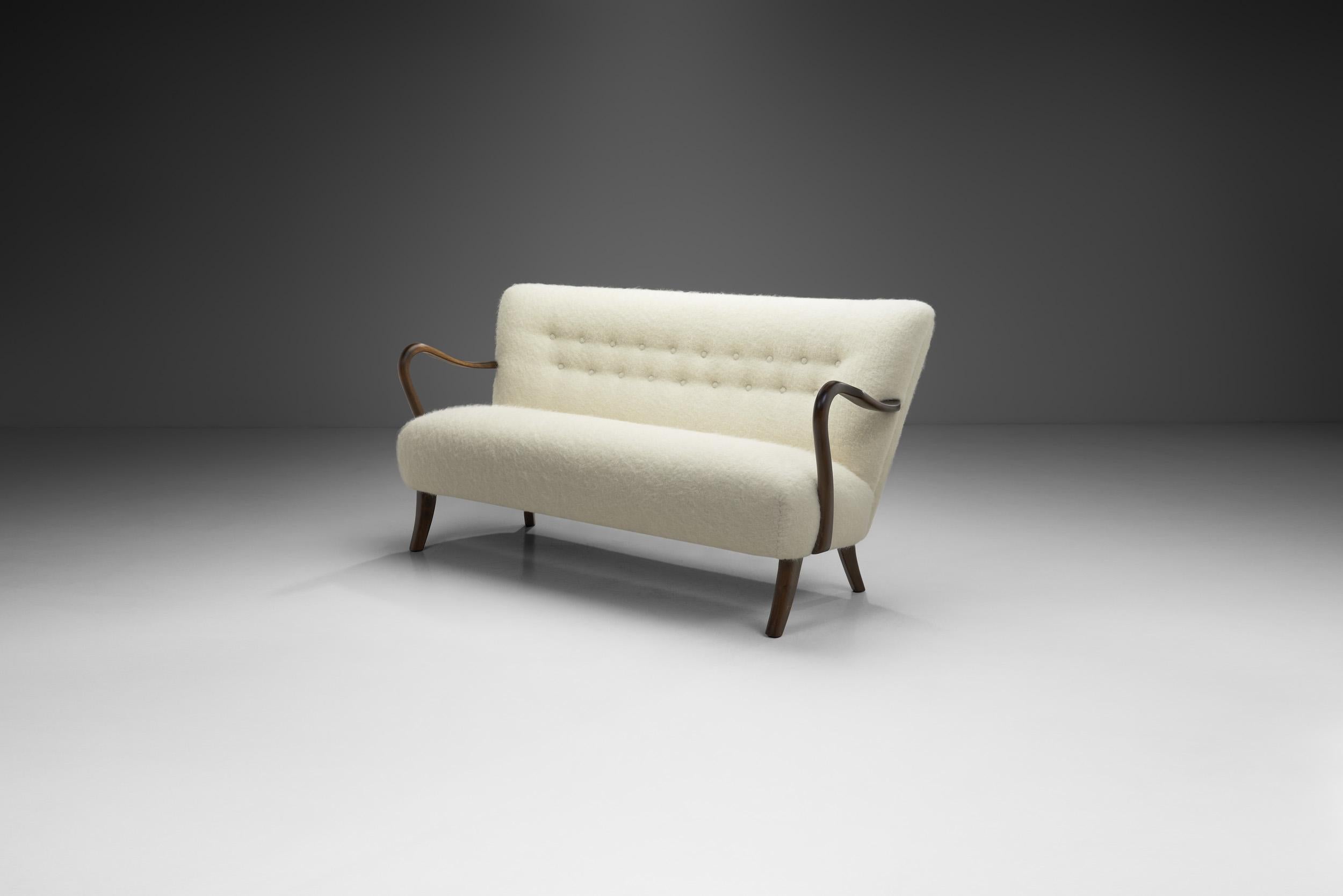 Danish Modern focused more on the aesthetics of modern design whilst employing the exquisite technique and material familiarity of highly skilled craftsmen known as cabinetmakers. Alfred Christensen’s present sofa in this style is a rare and