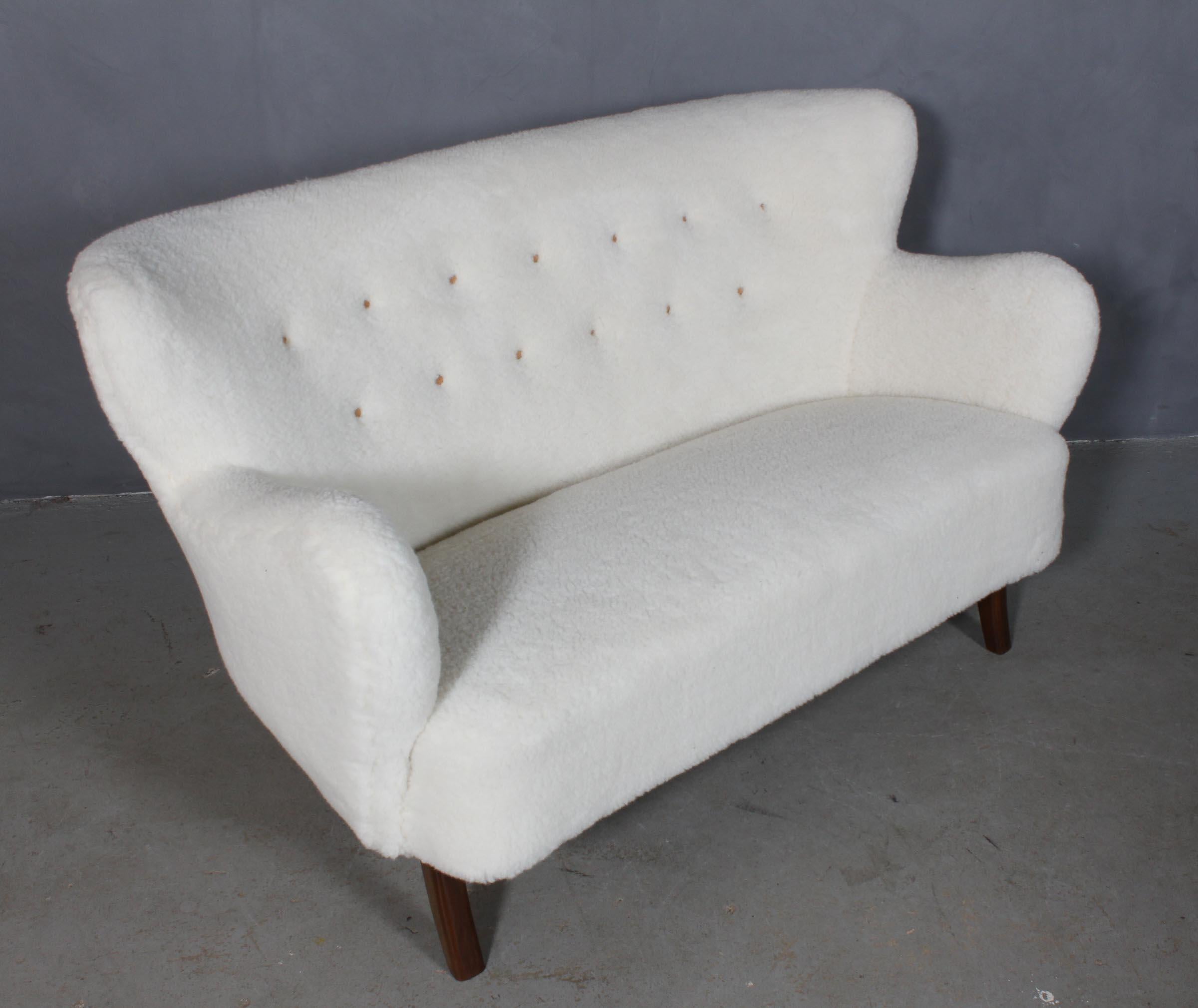 Alfred Christensen two seater sofa new upholstered with lamb wool.

Legs of stained beech.

Made in the 1940s by Slagelse Møbelværk.

  