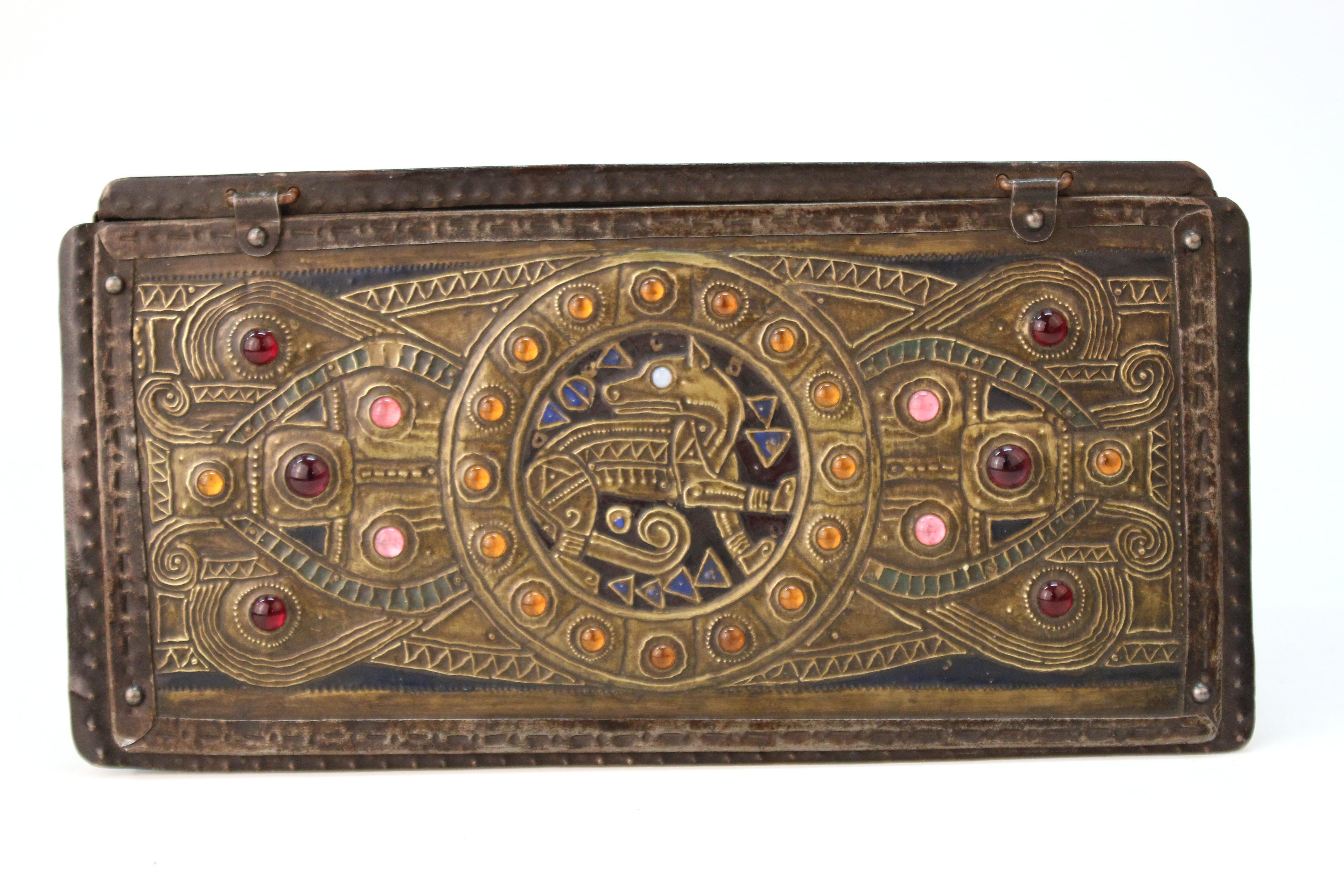 French Art Nouveau period box in metal repoussé´ panels with inserted colorful glass cabochon jewels, made by Alfred Daguet in the 1910s in Paris. The highly decorative brass lid panel has a central medallion with a dog and stylized natural motifs