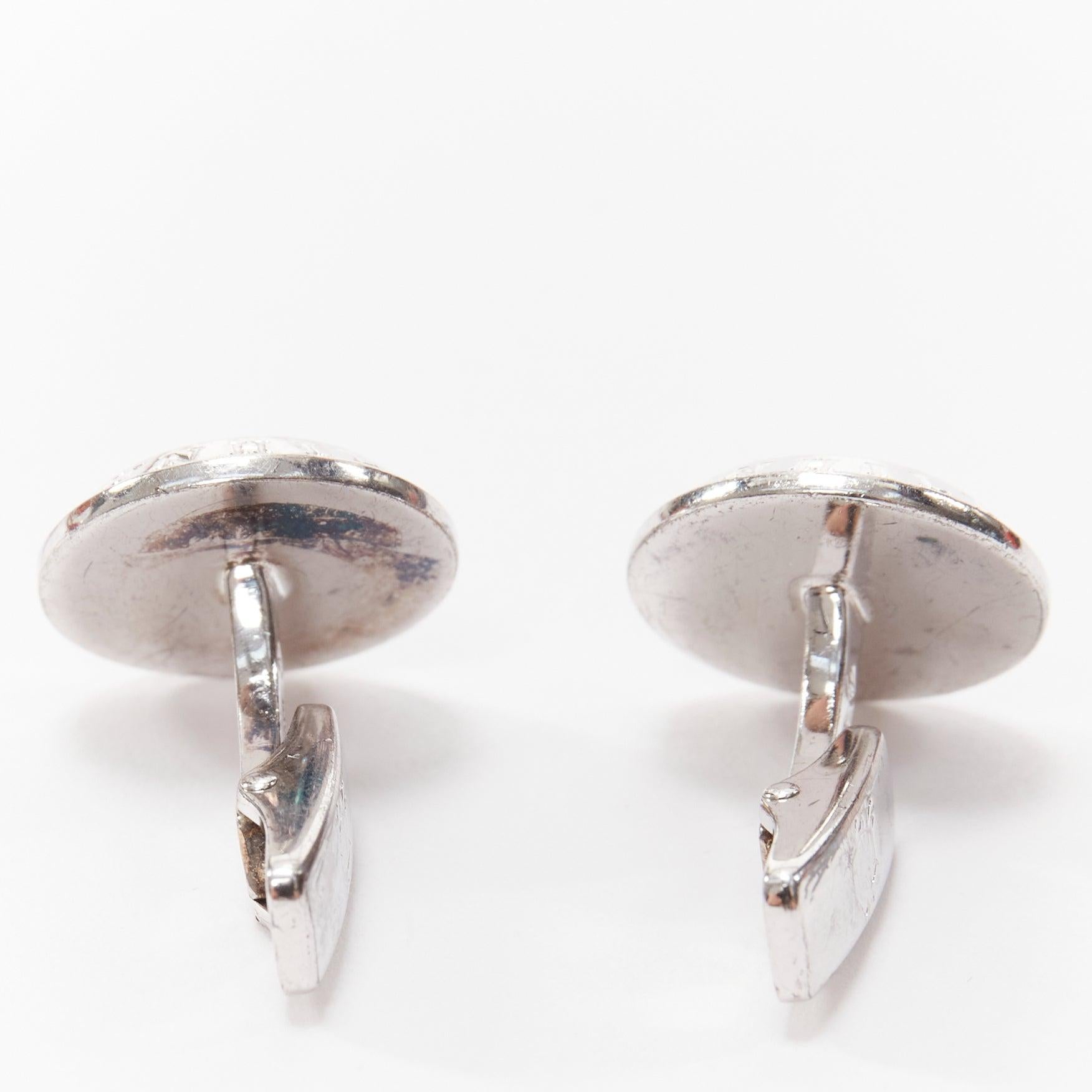 ALFRED DUNHILL 925 steel holographic mother of pearl round logo cufflinks
Reference: YIKK/A00050
Brand: Alfred Dunhill
Material: Metal
Color: Silver, Multicolour
Pattern: Solid
Closure: Clip On
Lining: Silver Metal

CONDITION:
Condition: Fair, this