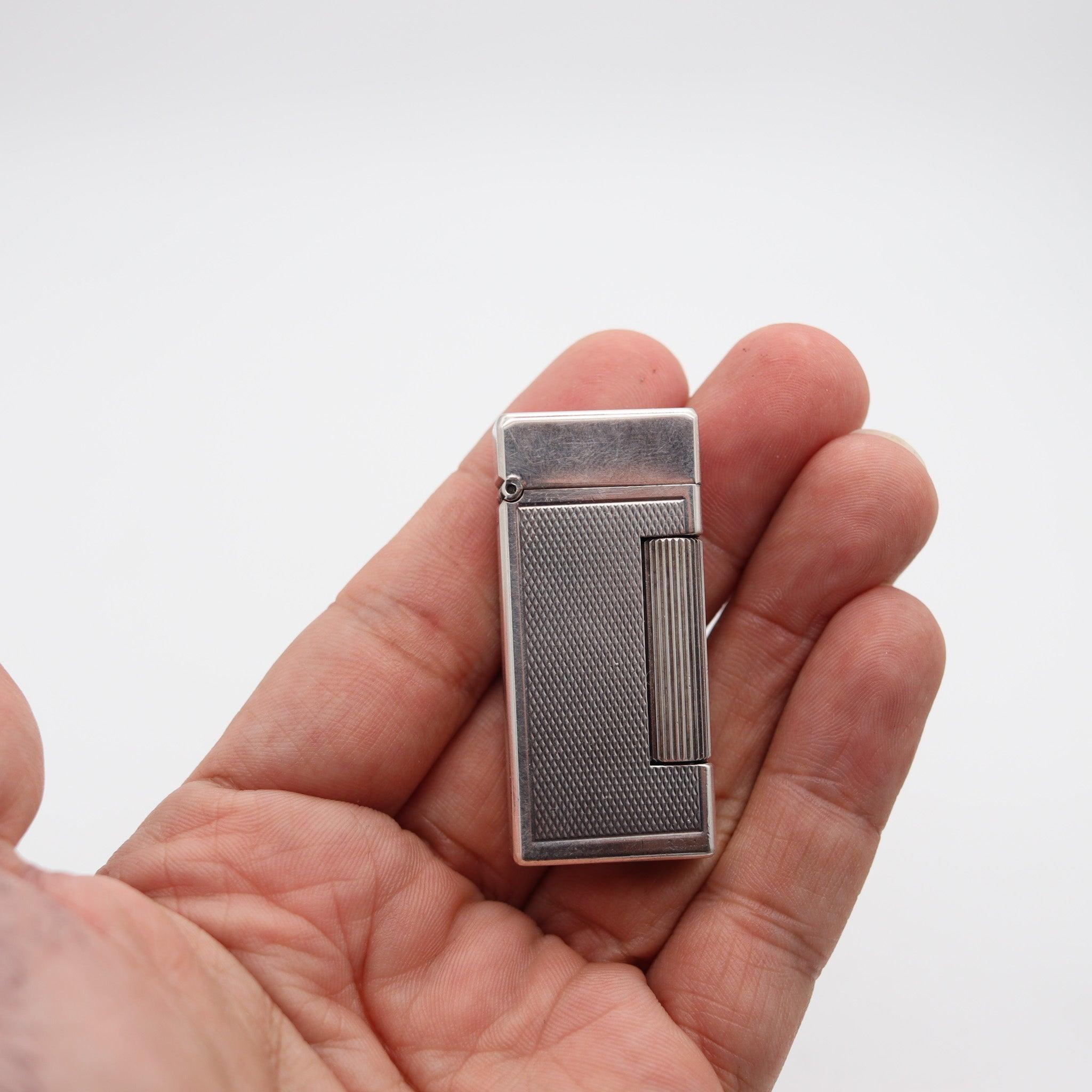 An automatic rollalite lighter designed by Alfred Dunhill.

This is a very scarce petrol pocket lighter, created in Switzerland by La Nationale company for the Alfred Dunhill Company in Paris France, back in the 1960. This semi-automatic lighter is