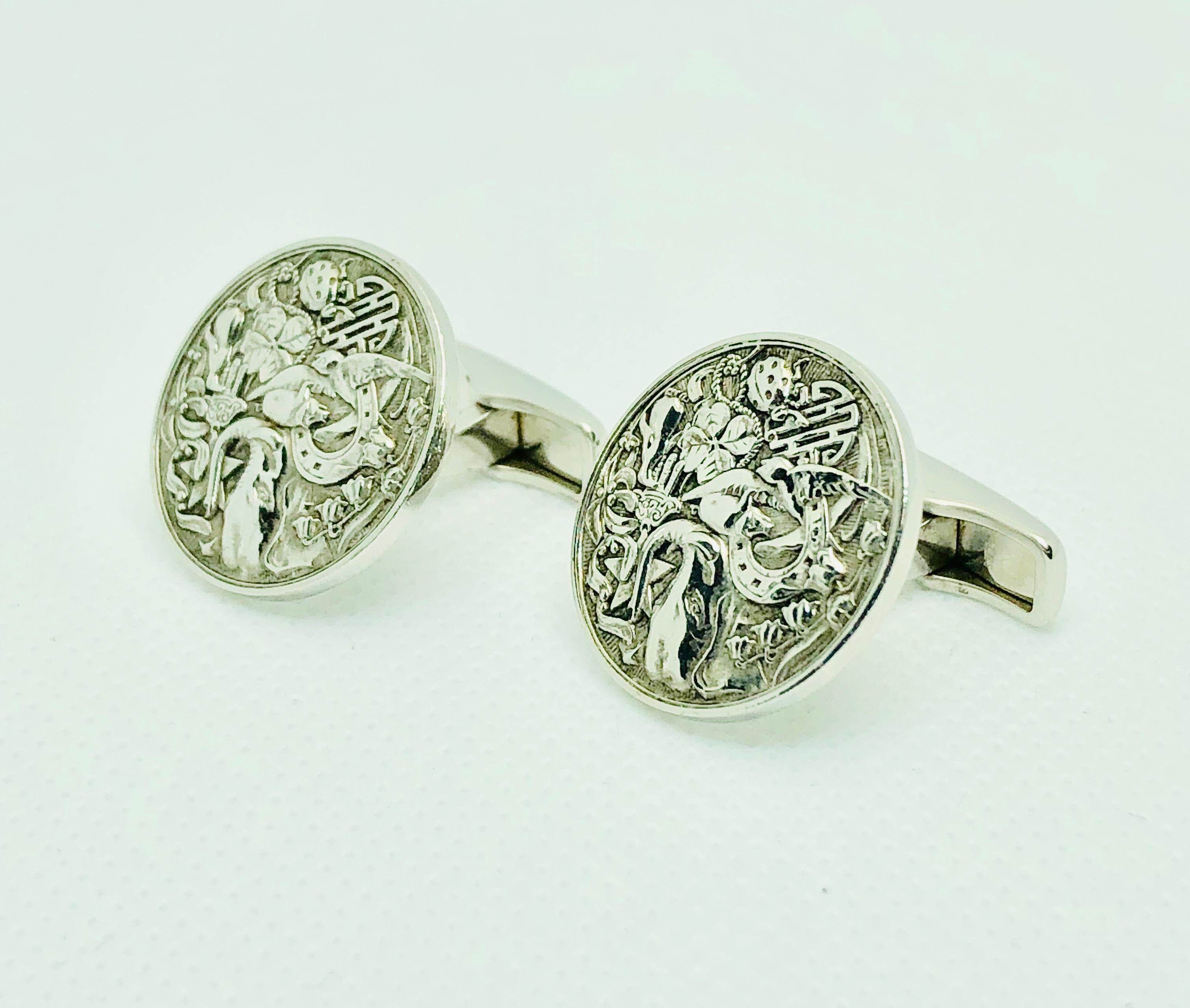 Gorgeous and Very unique Dunhill Cufflinks. They are .75 inches in diameter. Made in sterling silver they feature a montage of numerous animals (elephant head, bird, ladybug, pig and penguin) as well as a horsehoe, star of David with a hamsa and
