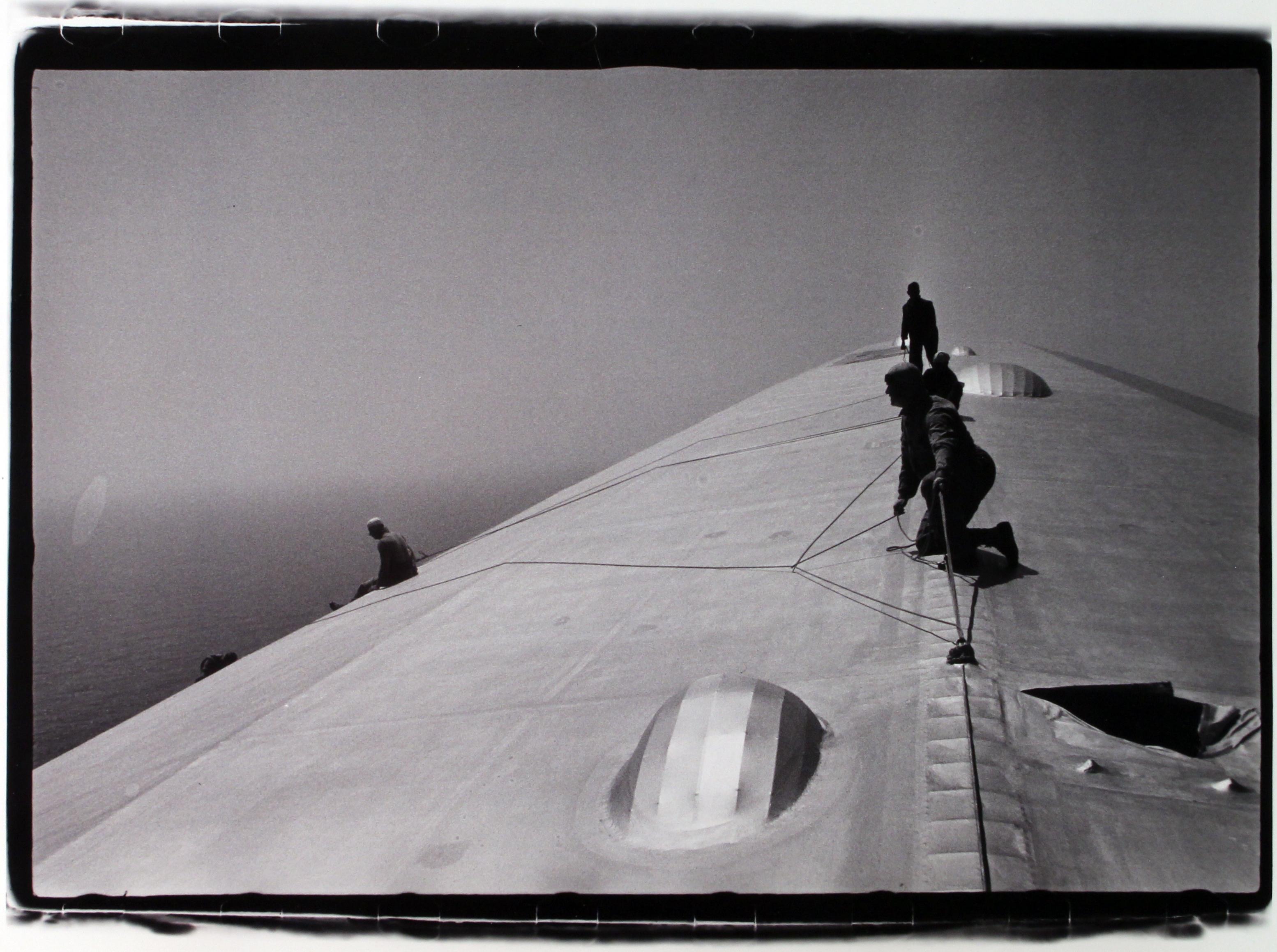 Alfred Eisenstaedt Black and White Photograph - Repairing The Hull Of The Graf Zeppelin During The Flight Over The Atlantic