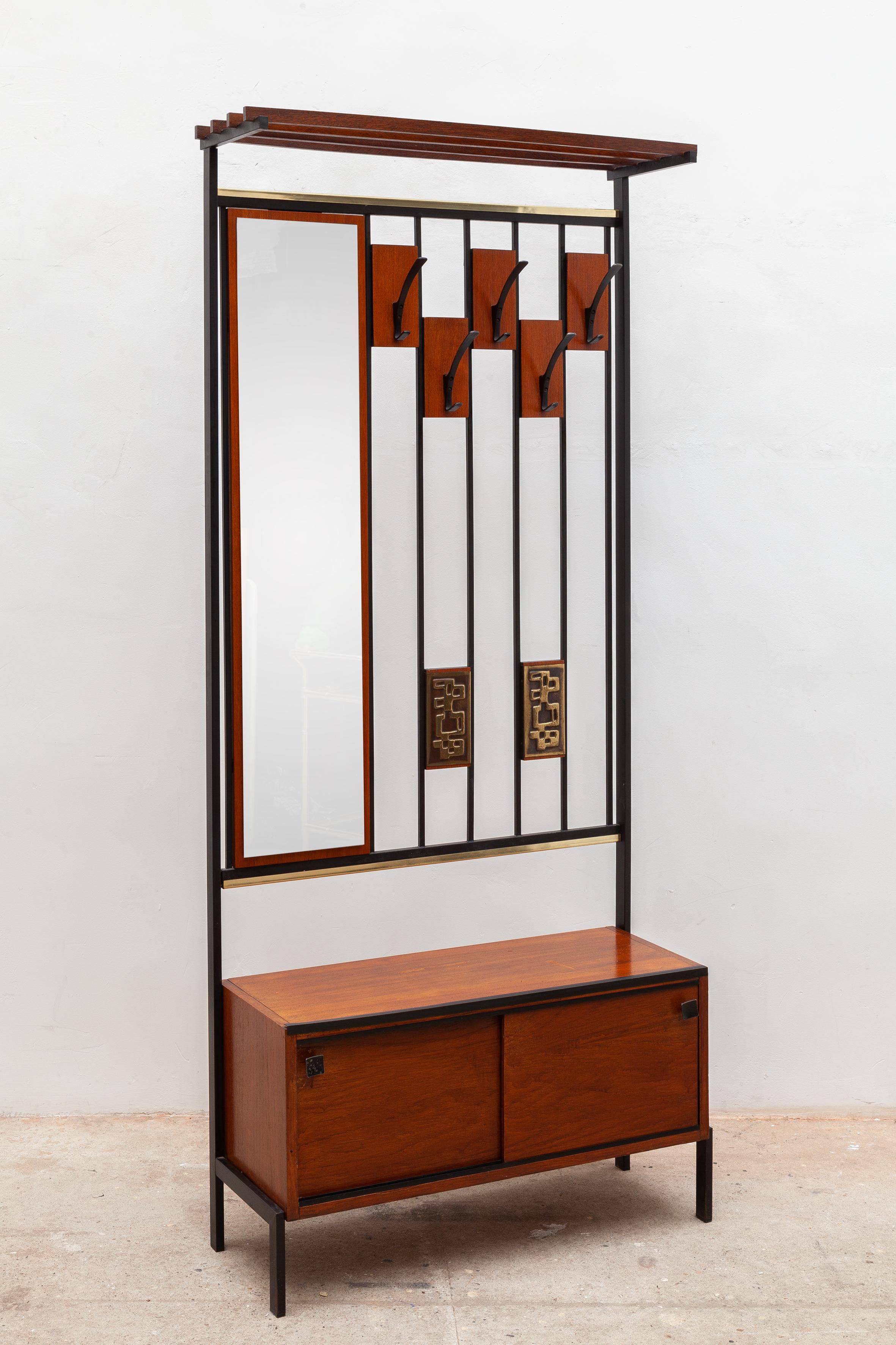 Alfred Hendrickx coat and hat rack. Vintage midcentury coat rack by Hendrickx, Belgium. Comprised of 5 metal black lacquered coat hooks, a hat rack, mirror, and shoe cabinet with sliding drawers. Made of teak with iron frame and artful metal, bronze