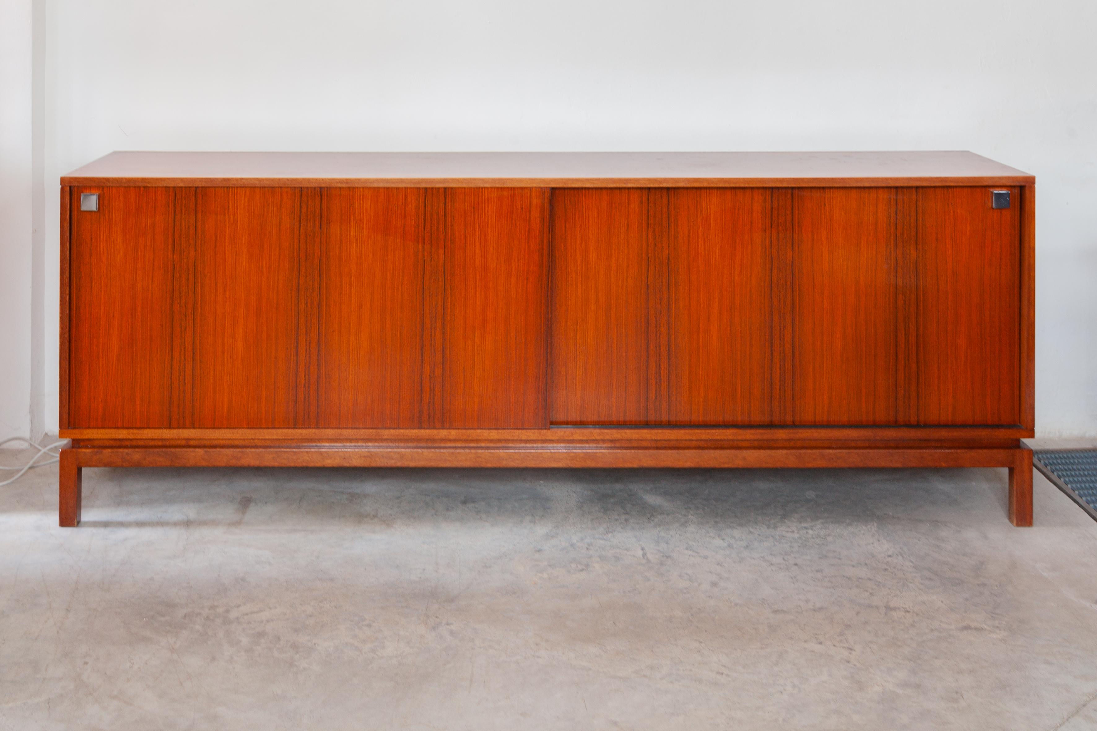 A large sideboard designed by the Belgian architect Alfred Hendrickx 1960, a minimalist sideboard of high quality and craftsmanship in Zingana wood consistently straight lines emphasize minimalism in its strength. The interior consists symmetrically