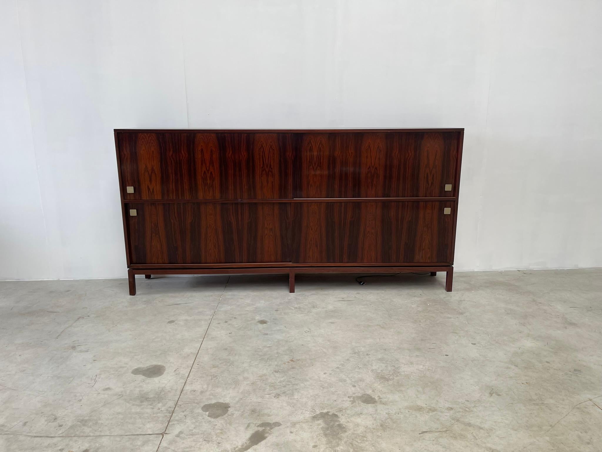 Very large minimalist rosewood highboard designed by Belgian designer Alfred Hendrickx for Belform in the 1960s.

Very spacious highboard  with 4 sliding doors and a bar compartment.

Good condition.

1960s - Belgium

Dimensions:
Lenght:
