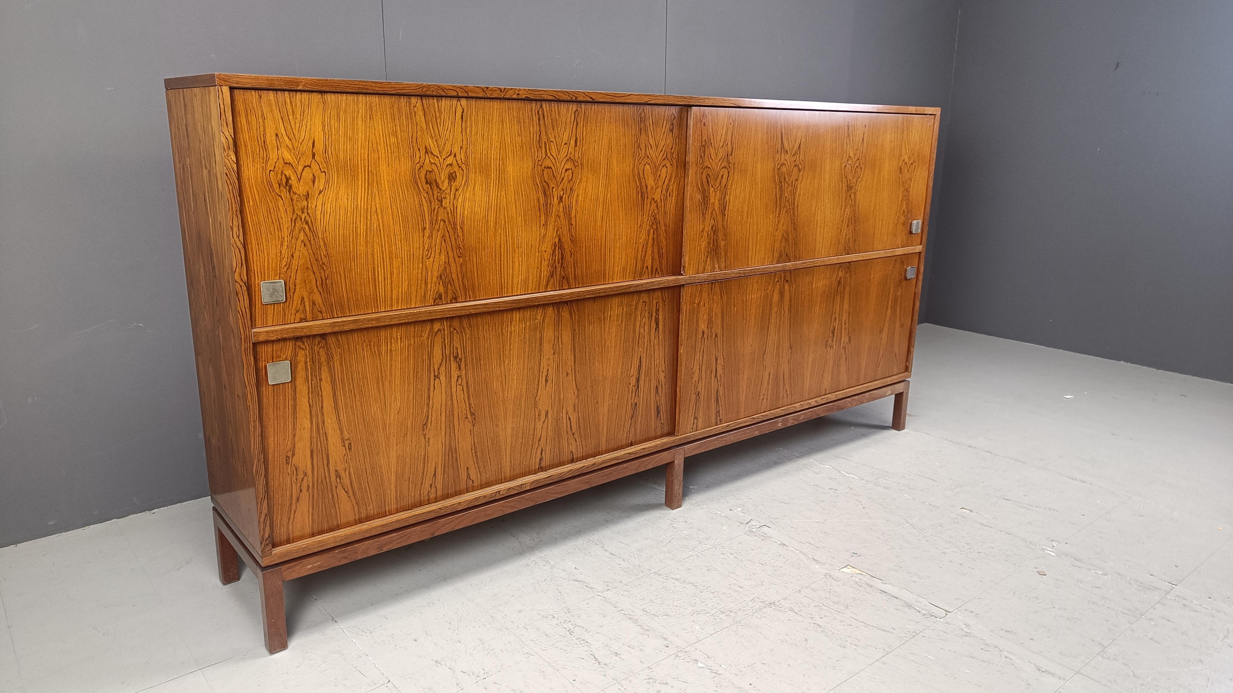 Very large minimalist wooden highboard designed by Belgian designer Alfred Hendrickx for Belform in the 1960s.

Very spacious highboard  with 4 sliding doors, 3 drawers and a bar compartment.

Good condition.

1960s - Belgium

Dimensions:
Lenght: