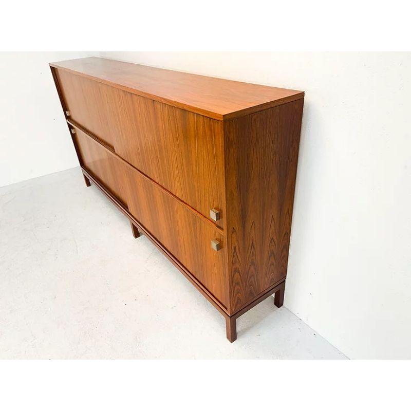 Alfred Hendrickx Highboard with Polished Steel Handles

Fantastic Belgian two level sideboard or highboard! This sideboard was designed by one of Belgium's most famous designers Alfred Hendrickx. He designed it in the 1960s for the Belgian