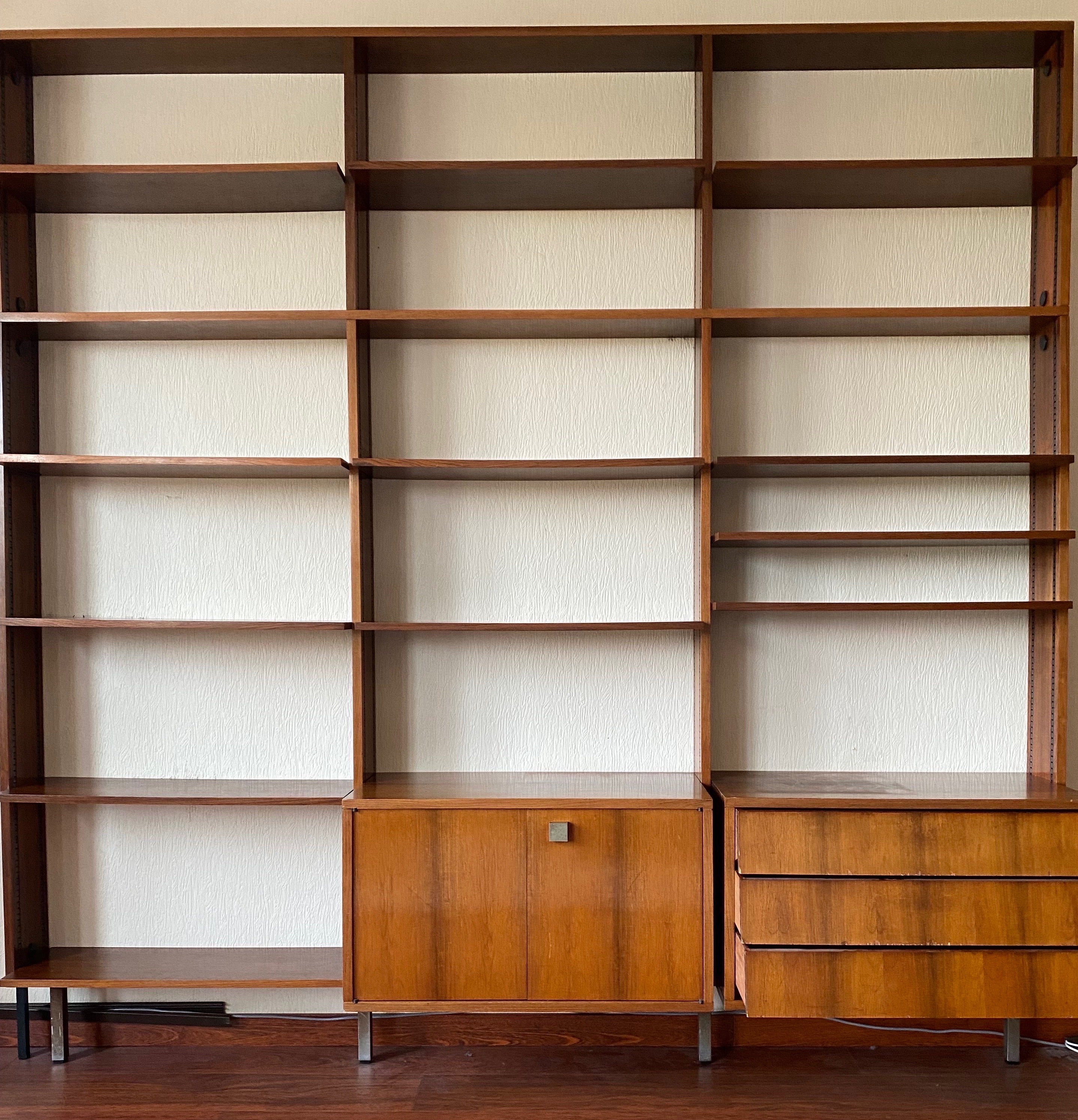 This beautiful Modular book case was designed by Alfred Hendrickx for Belform in the early 1960s Belgium handcrafted furniture. It has a Minimalist look with fine chrome legs. The wall unit offers a lot of storage space due the sixteen modular