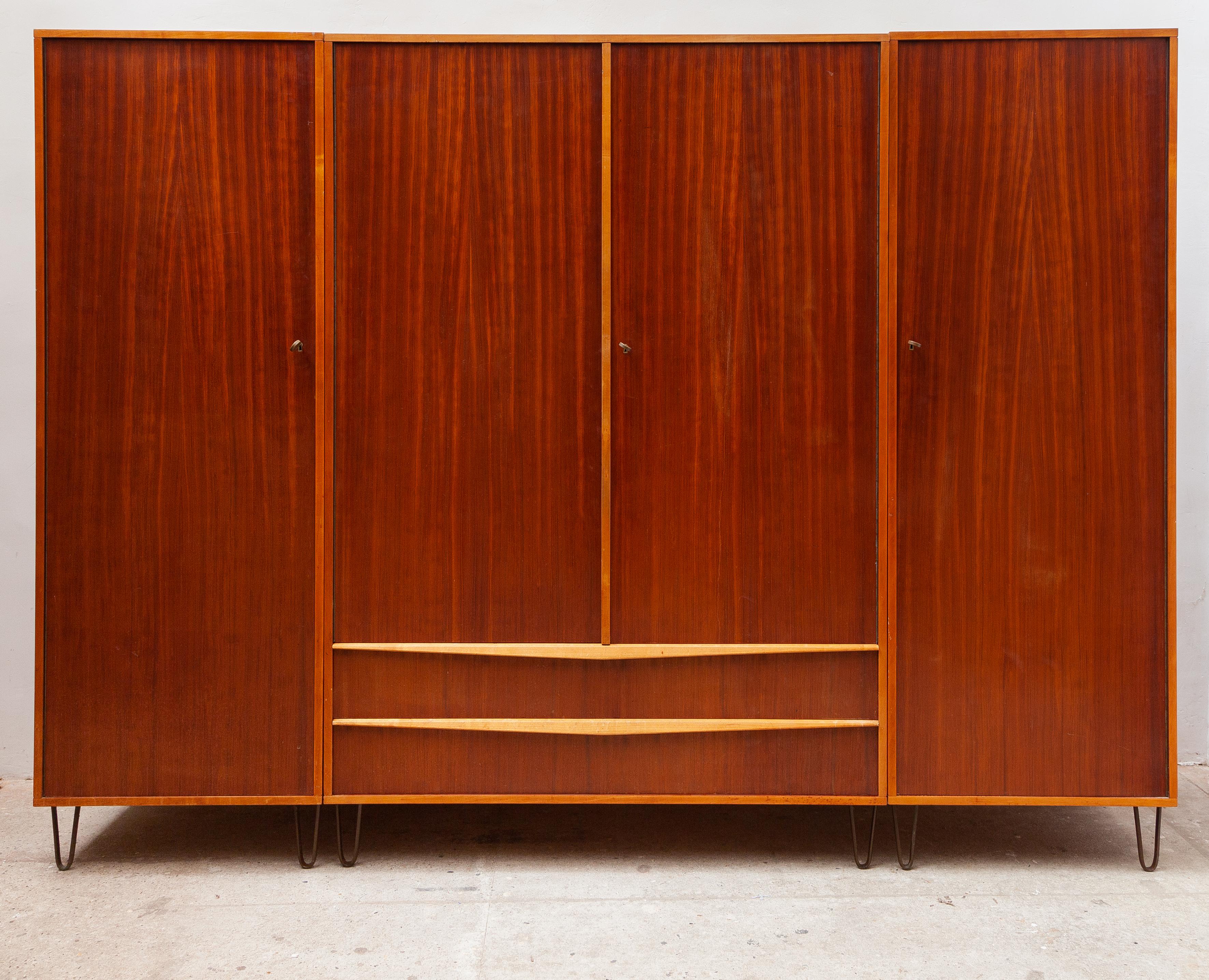 A very rare and unique piece of vintage design furniture.Original 1950s lined wardrobe designed by the Belgian designer Alfred Hendrickx for Belform from 1958. This closet features four doors with detailed three bronze keys. On the left side and