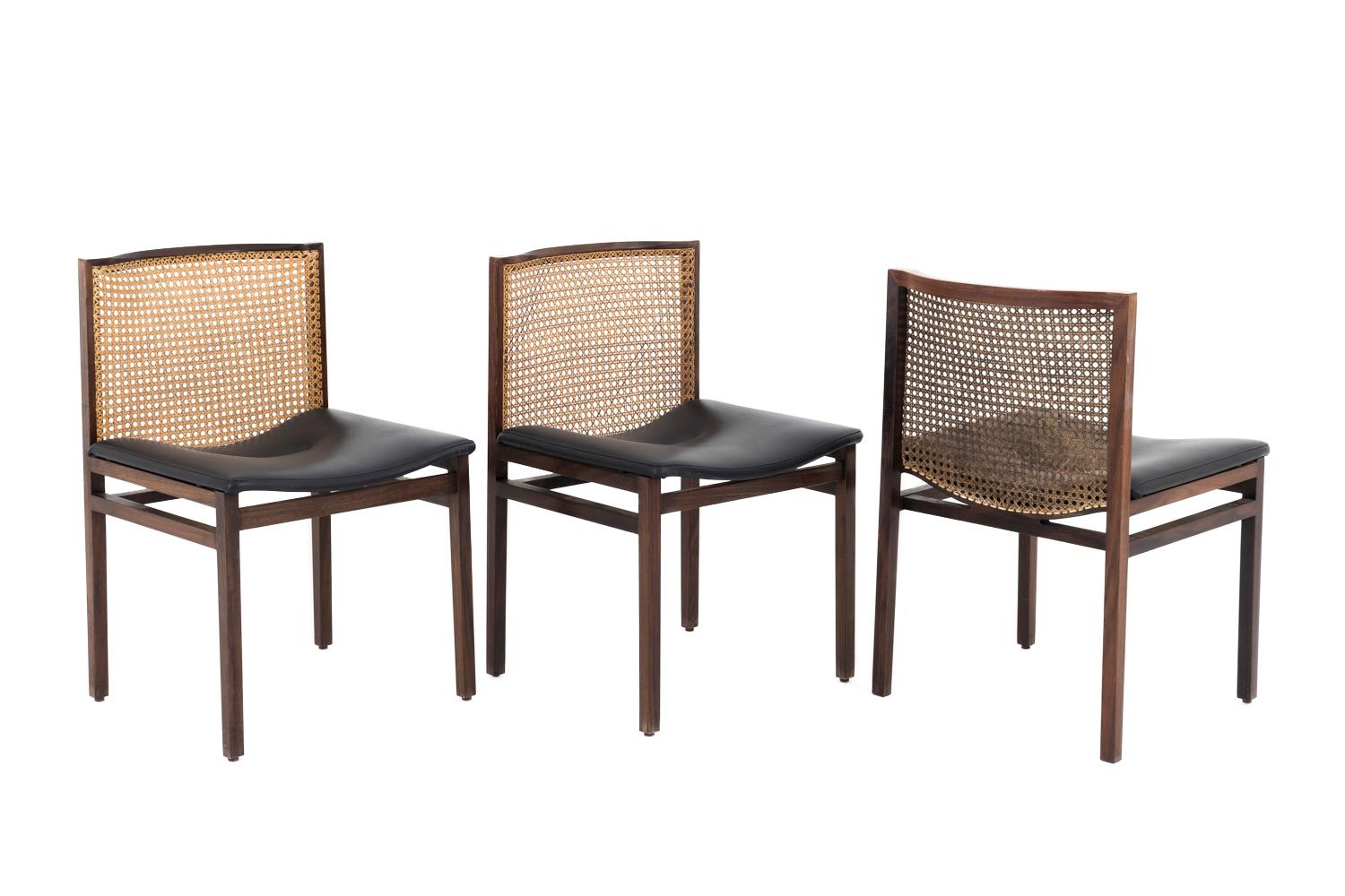 Alfred Hendrickx, attributed to. 

Set of six rosewood chairs standing on four square shaped legs, linked each other by four stretchers. Cane and slightly curved backrest. Curved black leatherette seat with central sewing forming a slight hollow.