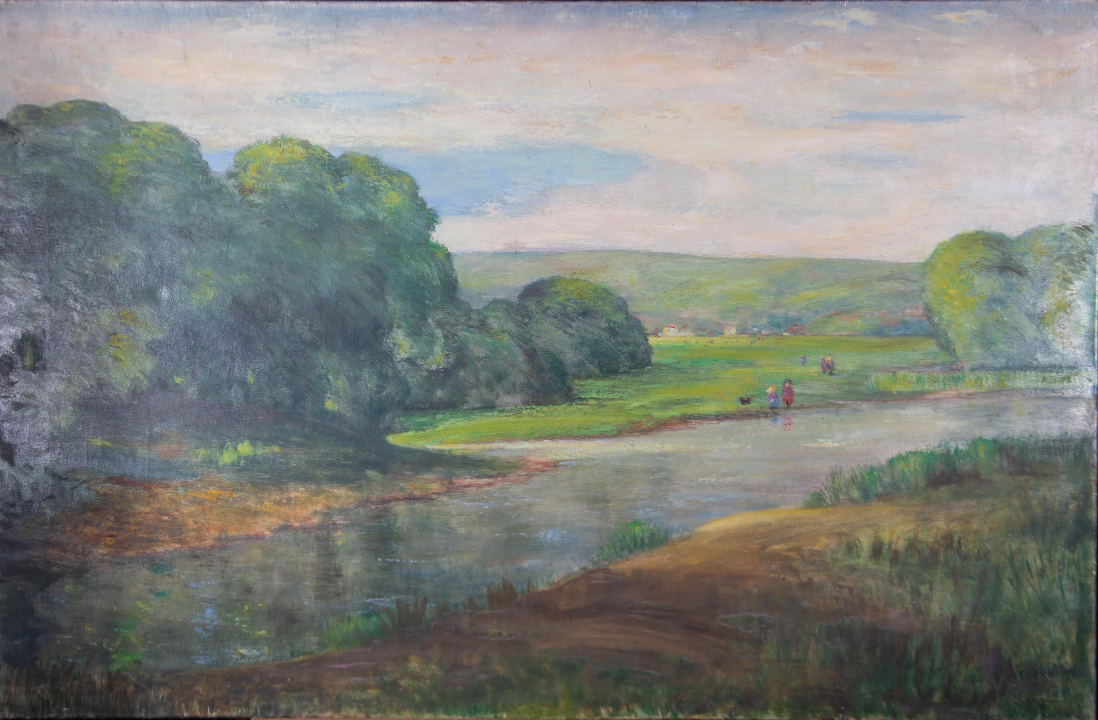A sunny oil landscape showing a lush green water meadow with verdant trees and rolling green hills in the distance. Figures stroll, with their dog, across the grass. The artist has signed and dated to the lower right corner. On canvas.
