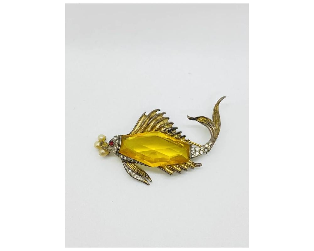 Rare Alfred Philippe Crown Trifari Sterling Silver Fish Brooch 
condition some tarnishing to the Silver throughout consistent with age 
there are some scratches throughout consistant with age and use 
the back has some of the gold fading you can see