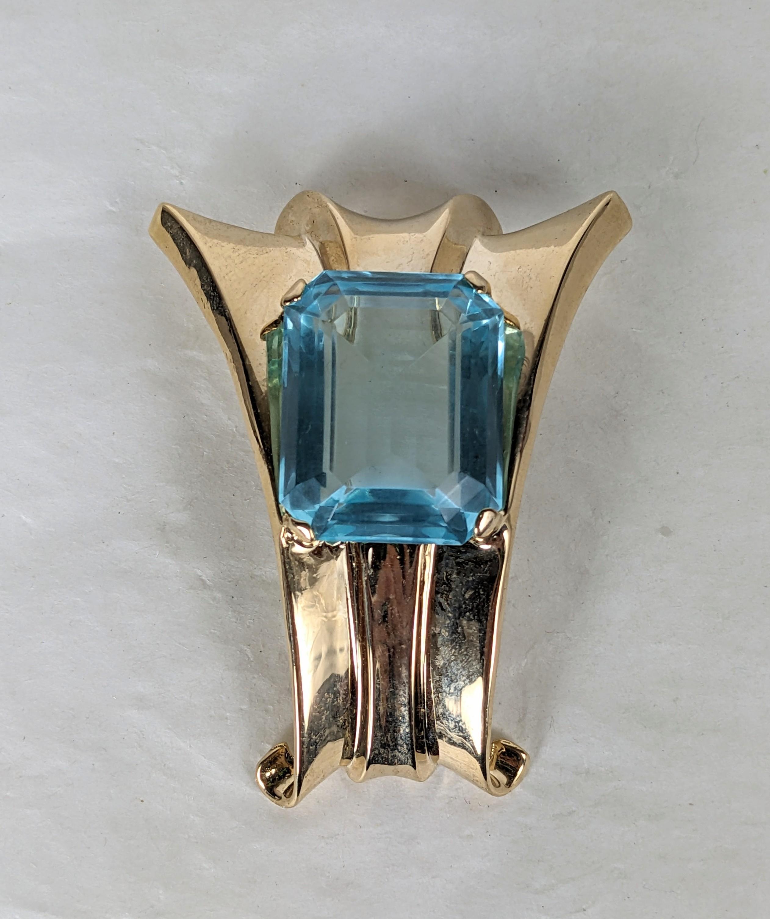 Alfred Philippe for Trifari faux aquamarine retro swirl clip brooch. Composed of yellow gold plated sterling silver ribbed chevron, with large rectangular focal aquamarine. Excellent Condition. 
L 2.25