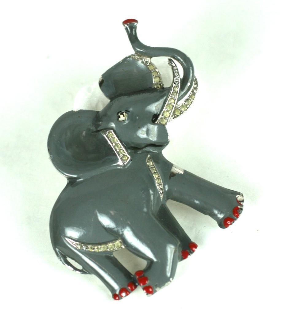 Charming Alfred Philippe for Trifari gray trumpeting and charging African elephant clip brooch of rhodium plated base metal, crystal rhinestone pave, and hand painted shaded cold enamel. 
Advertised in Women's Wear Daily 17 February 1939.
Excellent