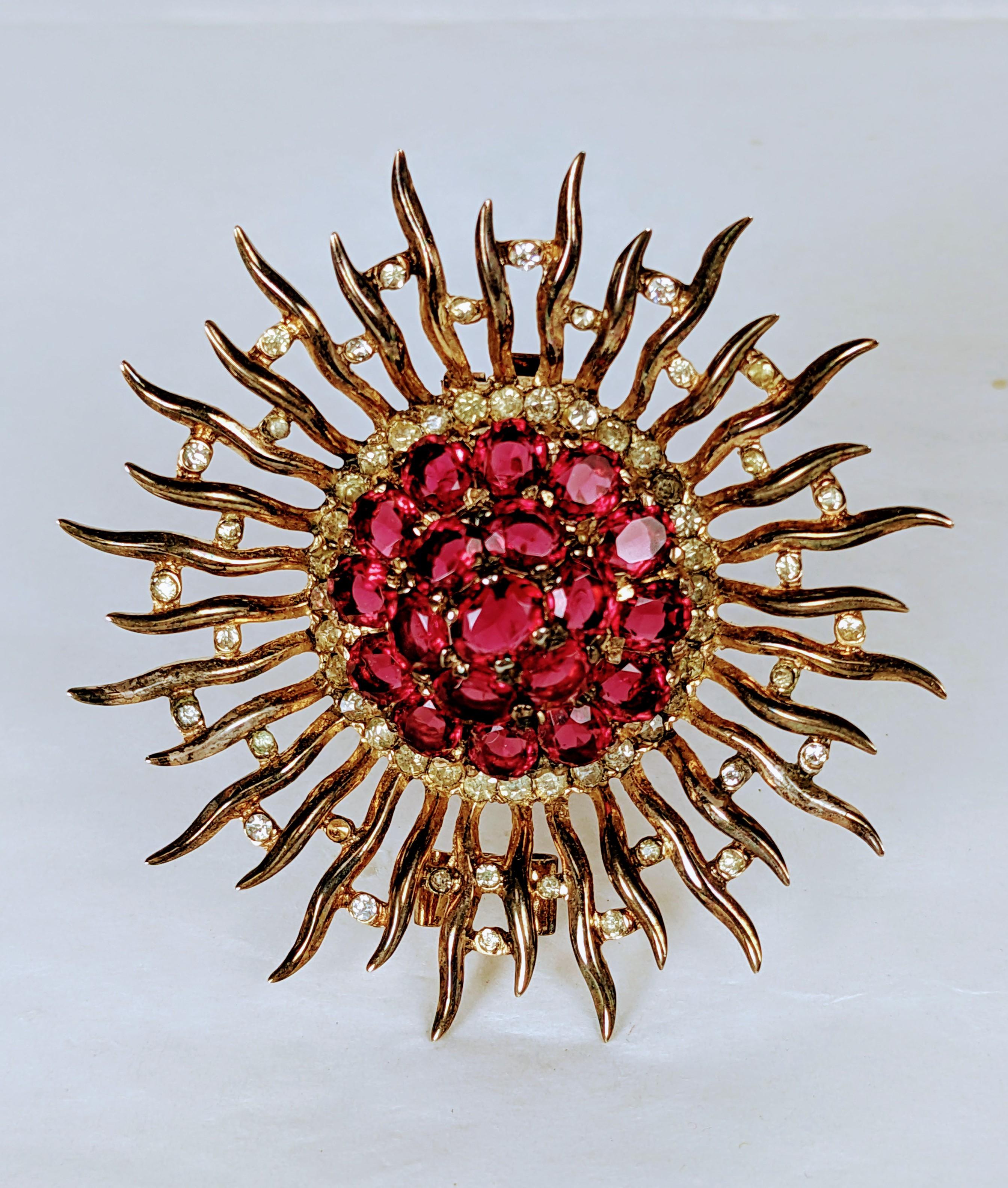 Alfred Philippe for Trifari large ruby sunburst clip brooch of gold plate sterling silver. With crystal rhinestone pave and oval faceted faux rubies. Inspired by the Sunburst  jewels by Fulco de Vedura, 
Note: See Brunialti, American Costume Jewelry