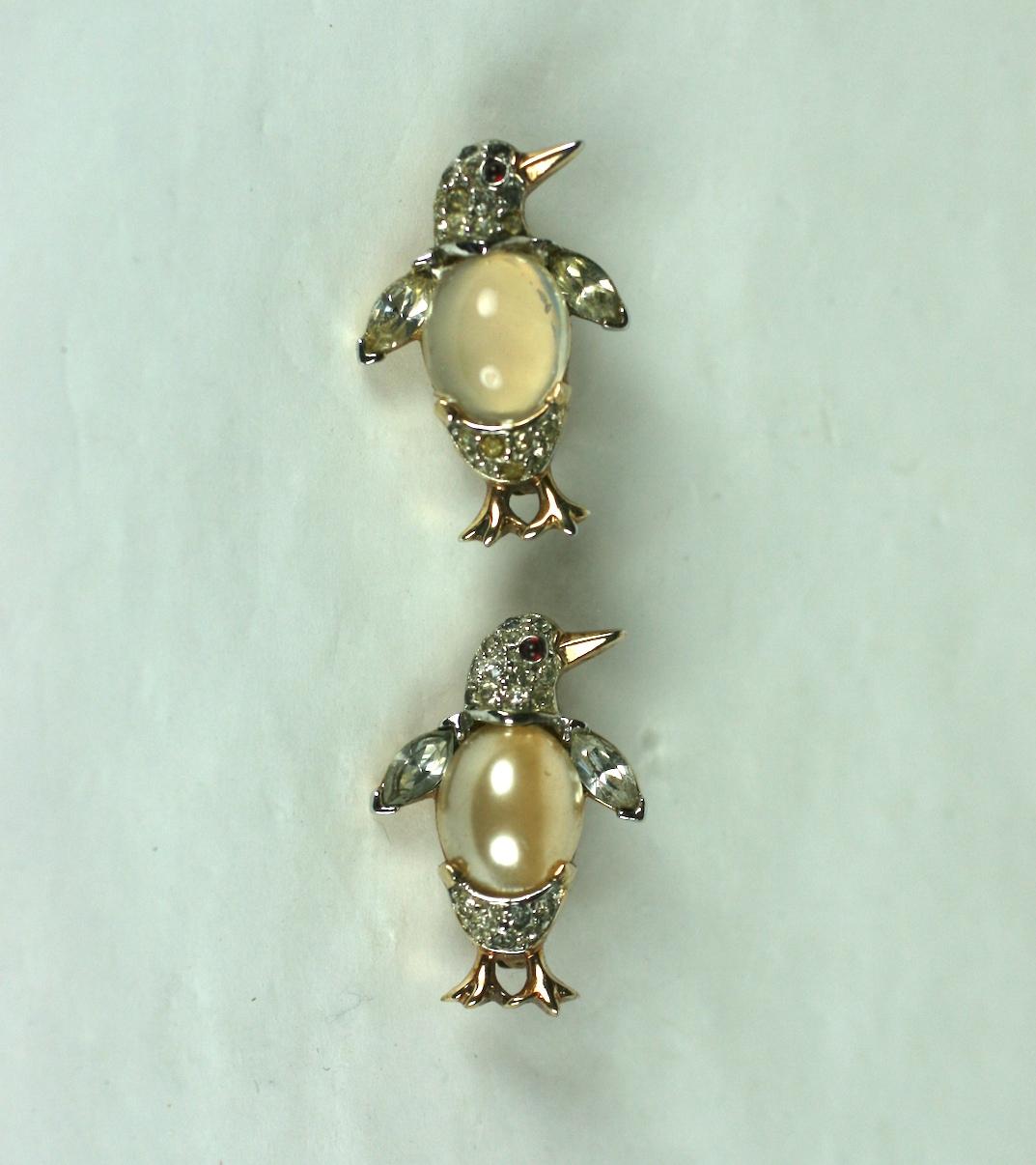 Pair of Alfred Philippe for Trifari crystal pave miniature pearl and jelly belly penguin brooches. Set in gold plated rhodium metal, with minute ruby cabochons and crystal marquise accents.
One is a pearl belly and the other is a moonstone jelly