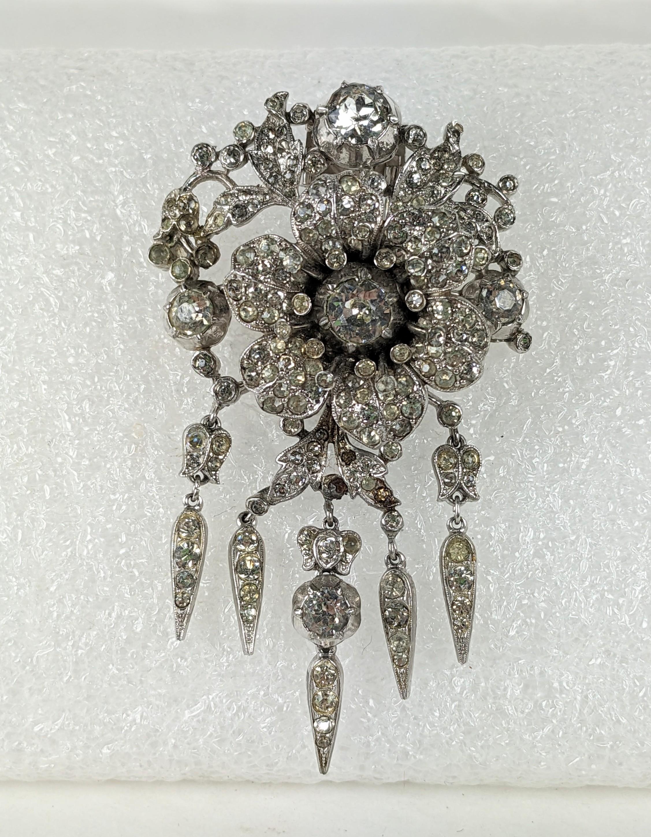 Trifari 'Alfred Philippe' 'Regence' Pave Rose Flower with Spangles and Six Radiant Leaves Pin Clip of rhodium plate base metal, rhinestones. The central rose trembles, all based on 18th Century diamond jewels. Marked: Trifari with Crown.
The series,