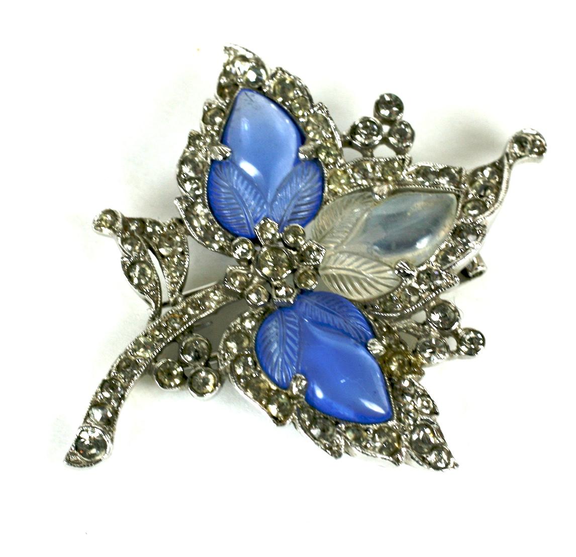 Trifari Alfred Philippe pale sapphire and moonstone fruit salad trefoil ivy leaf fur clip of rhodium plate base metal, molded  hand finished glass fruit salad stones and crystal rhinestones.
Marked: Trifari with Crown, Des Pat No 125841
Designer A