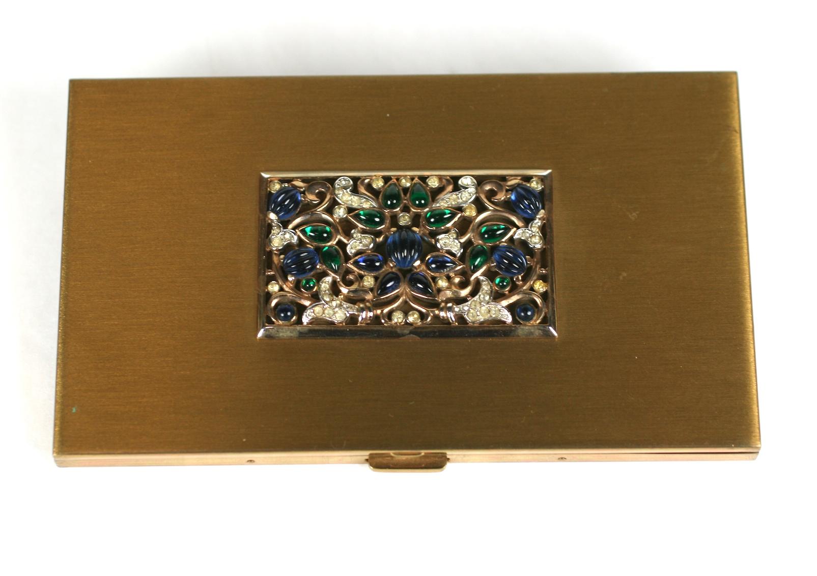 Rare Trifari Jewels of India Cigarette Case from the 1940's by Alfred Phillipe. A motif of faux sapphire and emerald Indian Moghul carved jewels are applied to a brass toned case which can used for cigarettes, cards or small flat items (not phones).