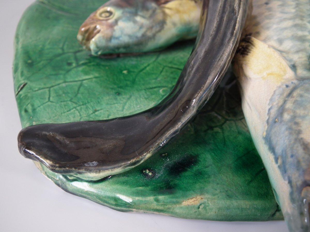 Alfred Renoleau French Palissy Majolica wall plaque which features an eel, fish and shellfish on a leaf. Coloration: green, cream, grey, are predominant. The piece bears maker's marks for the Alfred Renoleau pottery.