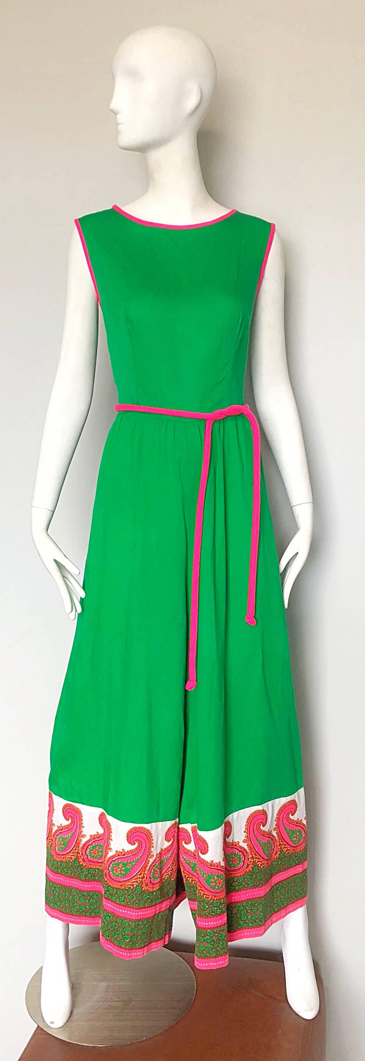 Rare 1960s ALFRED SHAHEEN kelly green and hot pink 
screen printed wide leg jumpsuit! Features shamrock kelly green with hot pink trim around the neck and sleeves, with a matching detachable tie belt. Hot pink, white and green paisley screen print