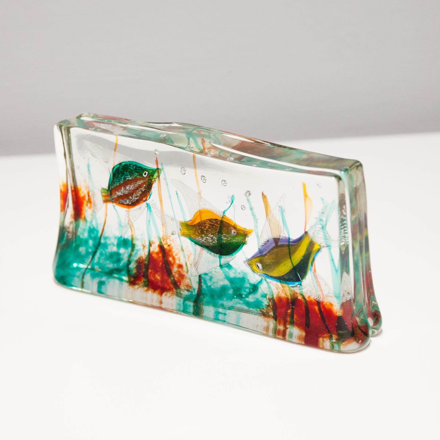 Very colorful Murano glass block Aquarium with inclusions of rare three fishes and sea plants within clear glass. Italy circa 1960s.