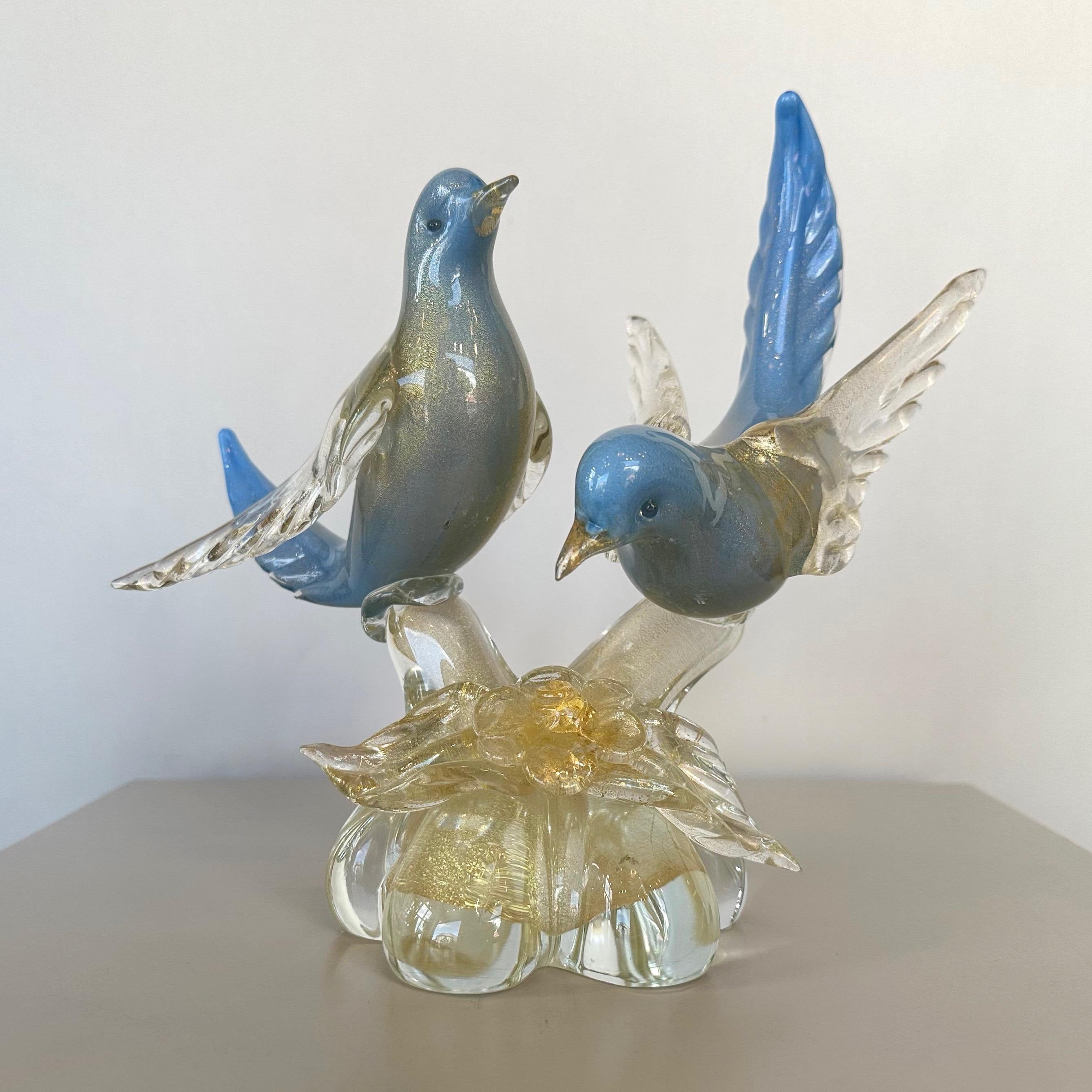 An enchanting and uncommon 1950s hand-crafted Murano glass gold-flecked blue birds sculpture by Salviati, with a design attributed to Alfredo Barbini.

Very skillfully executed life-size depiction of a gorgeous matched pair of animated birds—perhaps