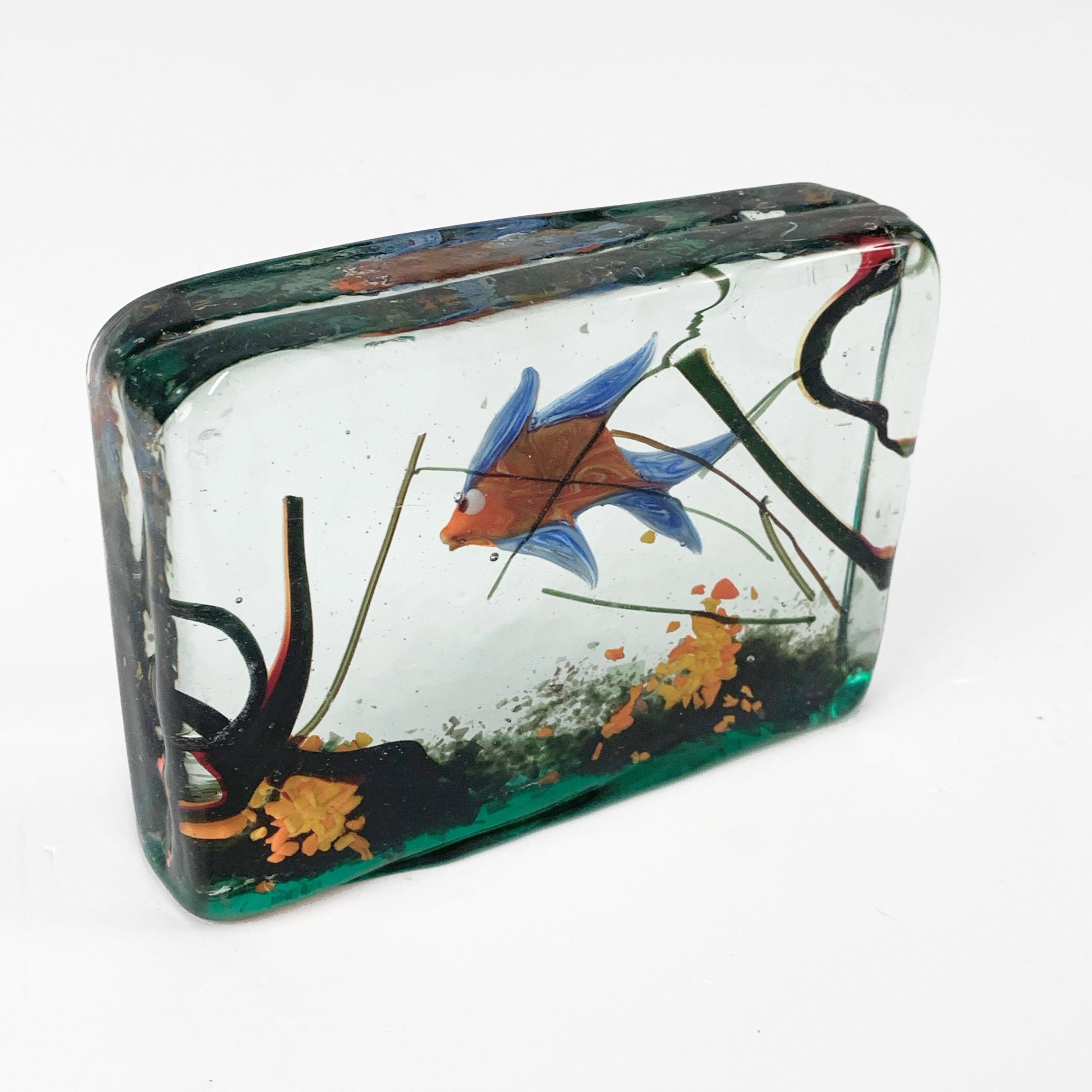 Wonderful sculpture of an aquarium tank with a red and blue fish, with highly artistic details in blown Murano glass. 

Attributed to the artist Alfredo Barbini for Cenedese company. A wonderful addition for decorating a midcentury living room or