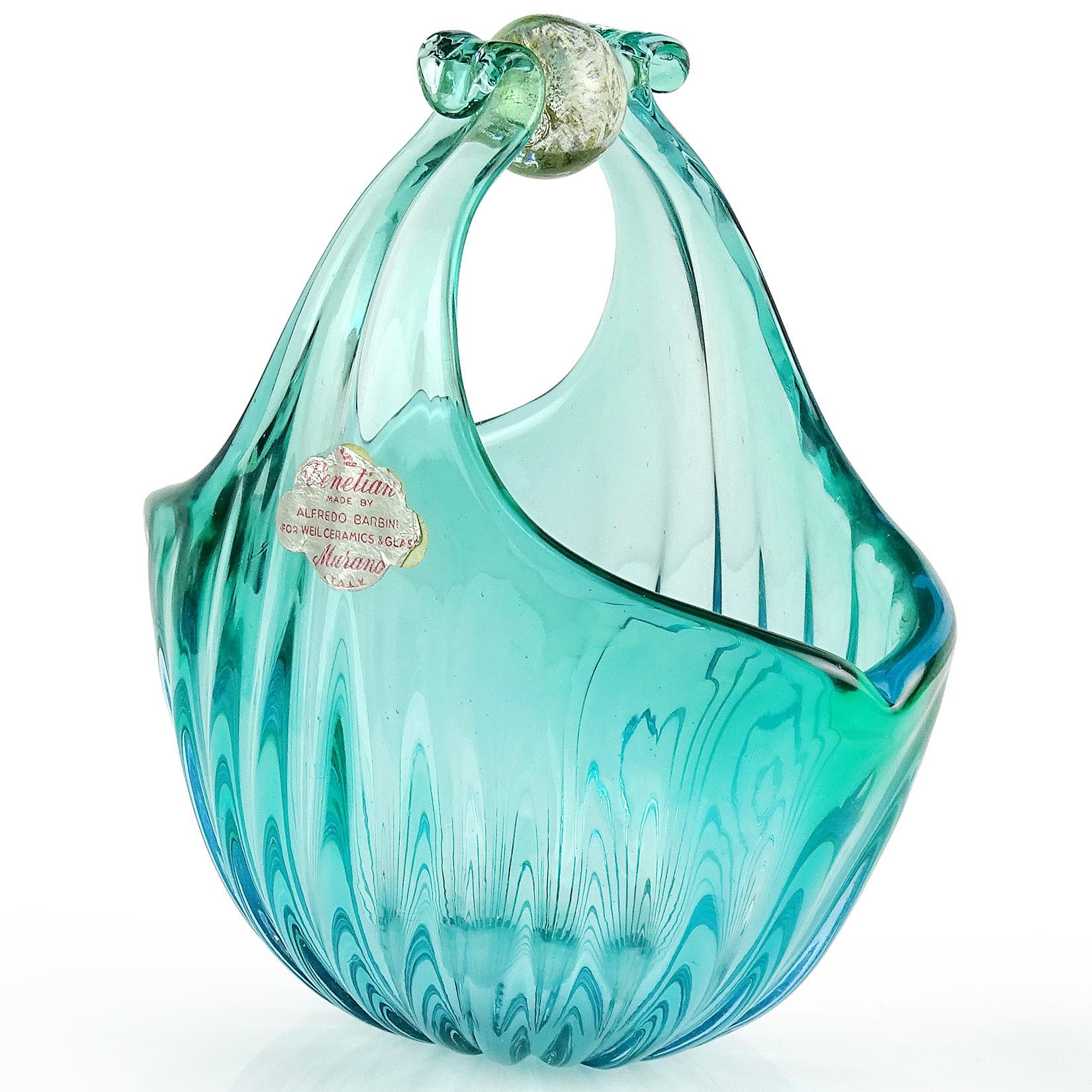 Beautiful vintage Murano hand blown Sommerso aqua blue green and gold flecks Italian art glass flower basket or vase. Documented to designer Alfredo Barbini and published in his catalog, circa 1950-1960. Still retains the original gallery label. It