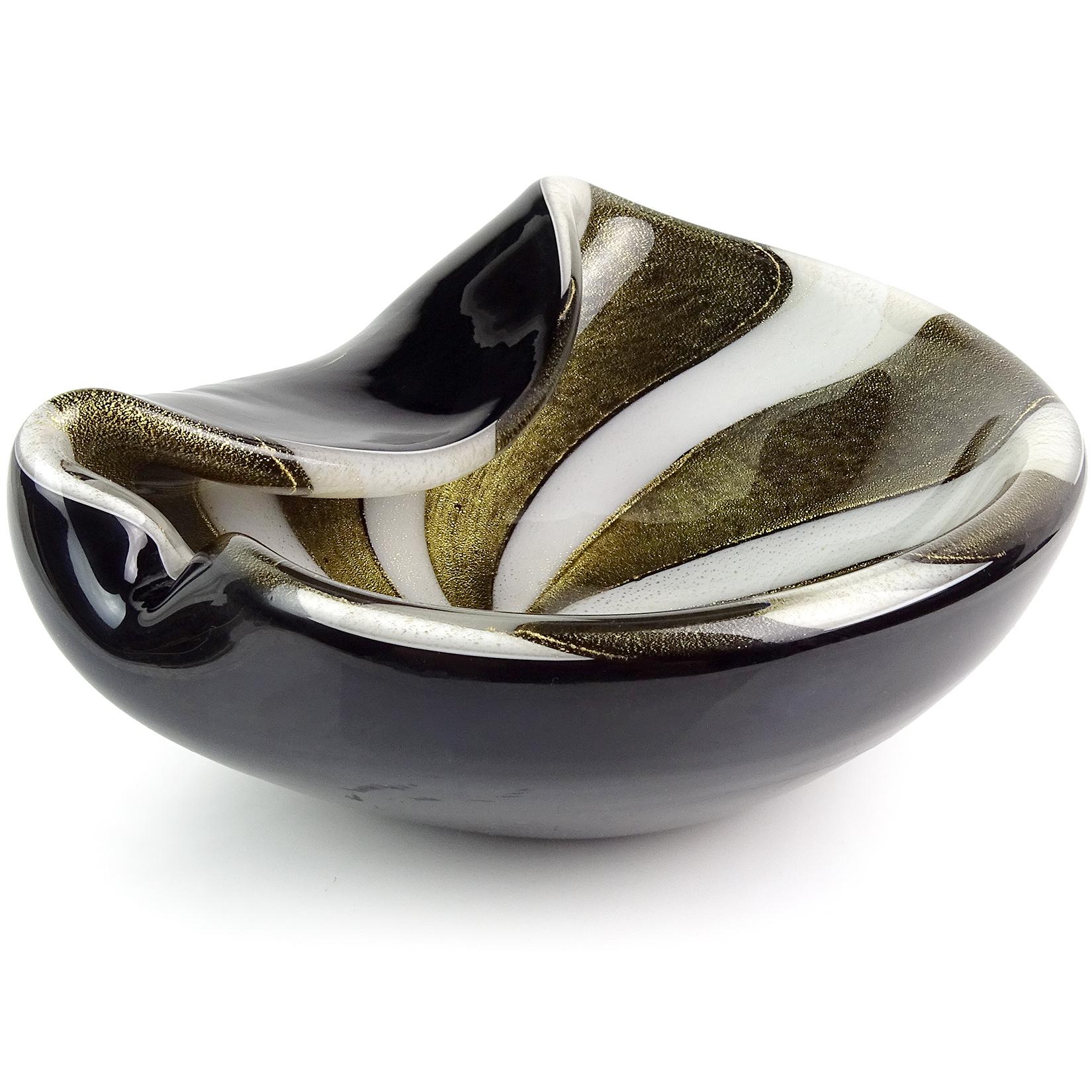 Beautiful Murano hand blown black, gold flecks and white stripes Italian art glass decorative bowl. Documented to designer Alfredo Barbini, circa 1950s. The piece has a folded over and pinched rim, profusely covered in gold leaf. Striking design.