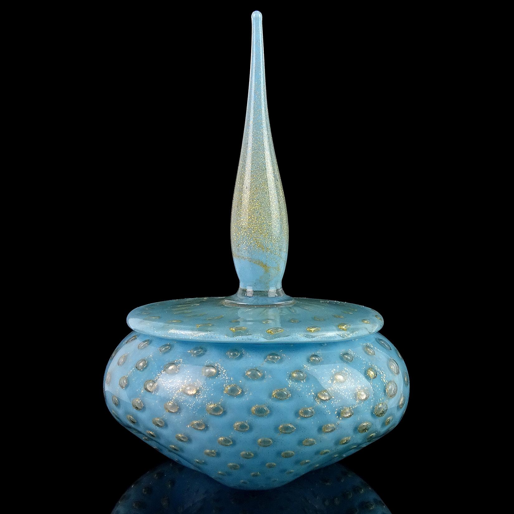 Gorgeous vintage Murano hand blown blue, controlled bubbles and gold flecks art glass powder or jewelry box. Documented to designer Alfredo Barbini, circa 1950s. The piece has three cute dimples on the body, with a spike top decoration. The gold