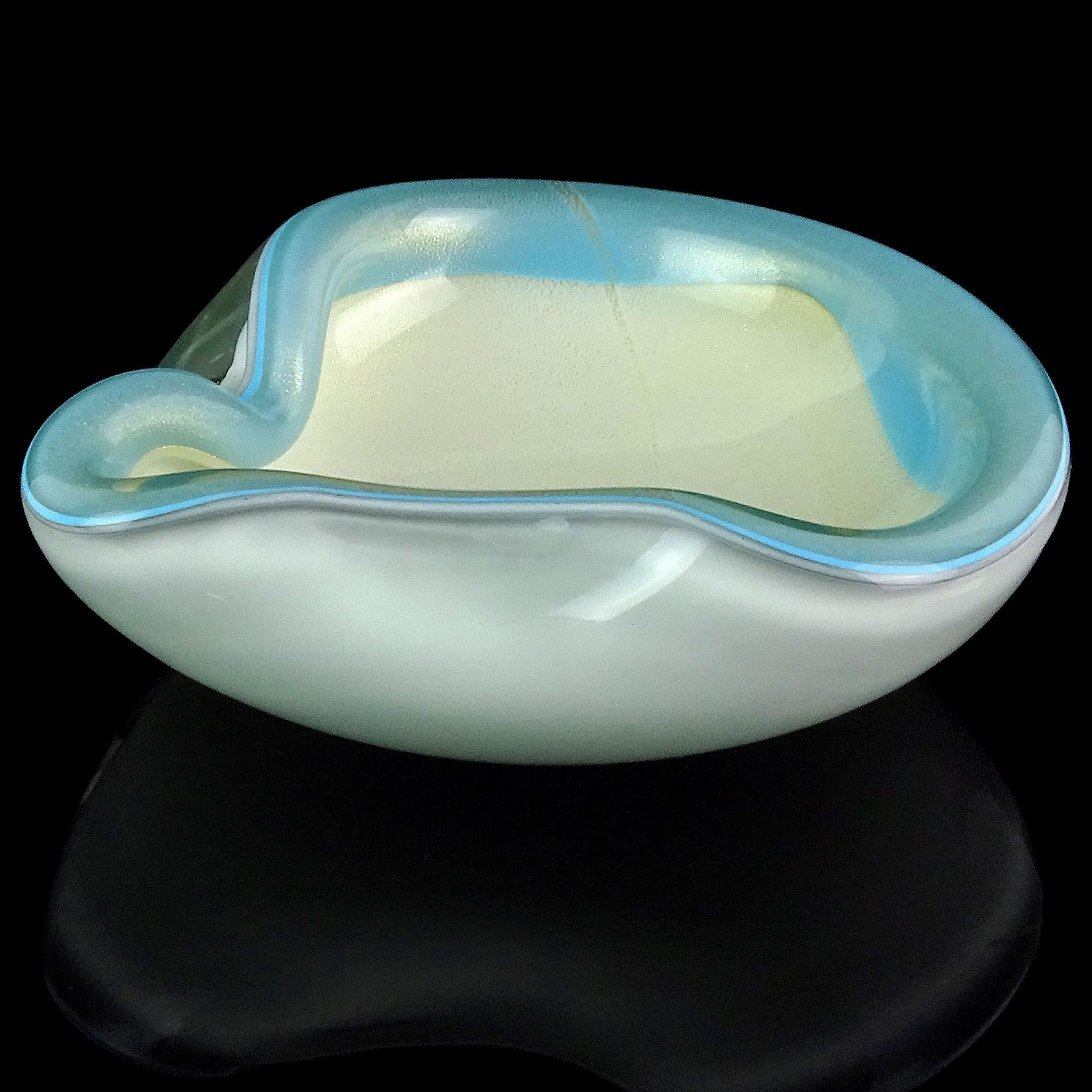 Beautiful vintage Murano hand blown white and gold flecks Italian art glass bowl with blue decoration around the rim. Documented to designer Alfredo Barbini. The piece is profusely covered in gold leaf. Can be used as a display piece on any table.