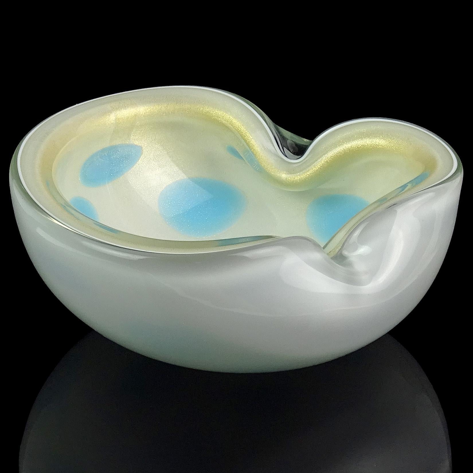 Beautiful Murano hand blown white with blue spots and gold flecks Italian art glass bowl / dish. Documented to designer Alfredo Barbini. Has heavy gold leaf on the inside of the bowl. Great shape, with two indents on the rim. Measures: 6 1/4” x 6