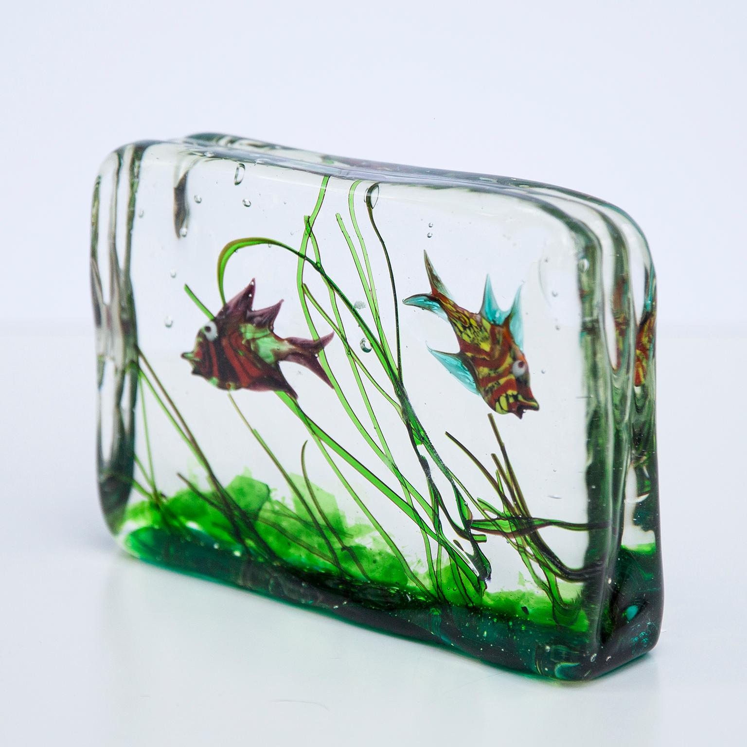 Wonderful Murano glass block with inclusions of two fishes and sea plants within clear glass. Italy, circa 1960s.

 