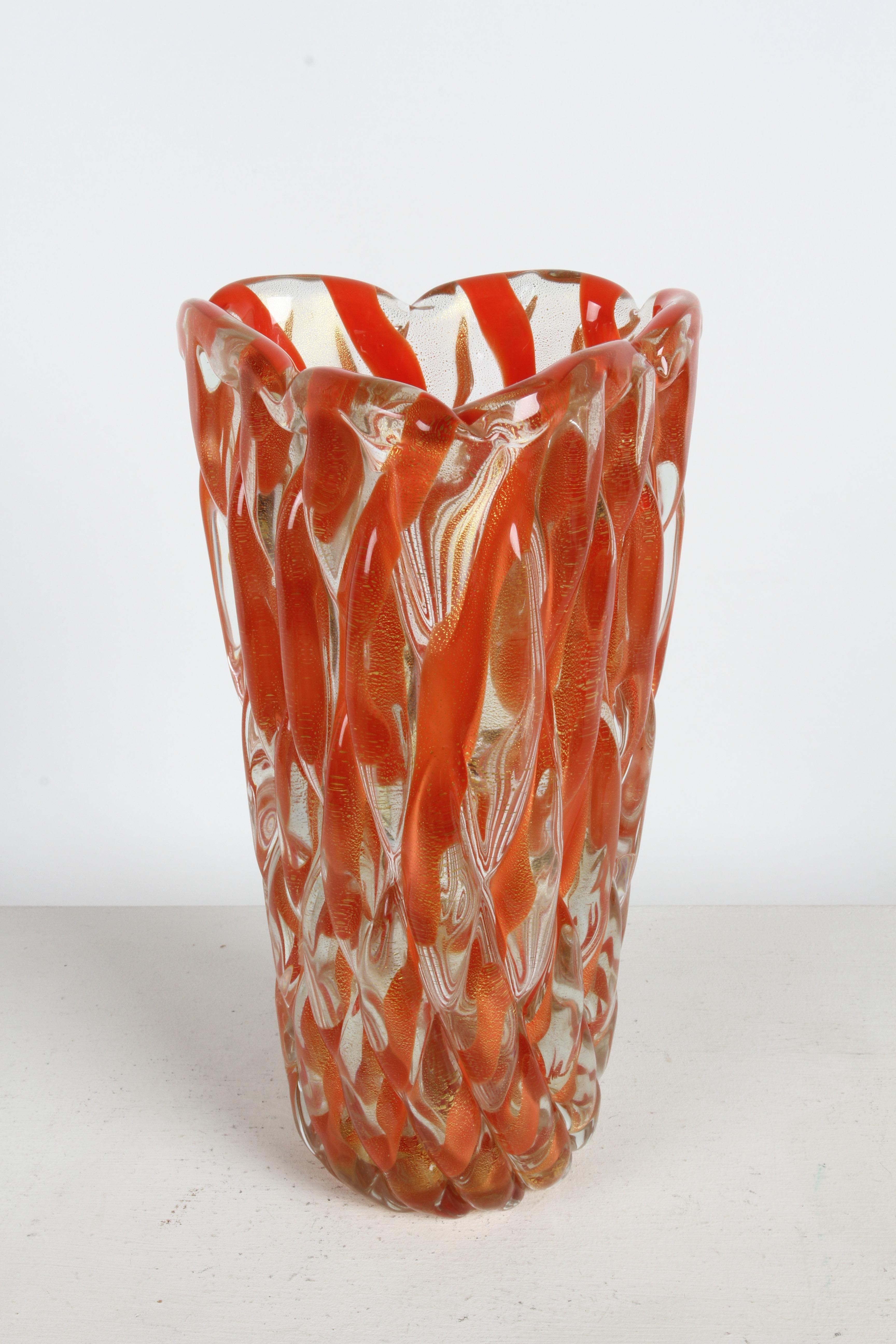 A large and heavy Mid-Century Modern hand-blown Murano art glass vase designed by Alfredo Barbini (1912-2007), circa 1950s. Tall triangular form with thick twisted ribbed glass of coral / orange striped glass with gold fleck and scalloped top. 