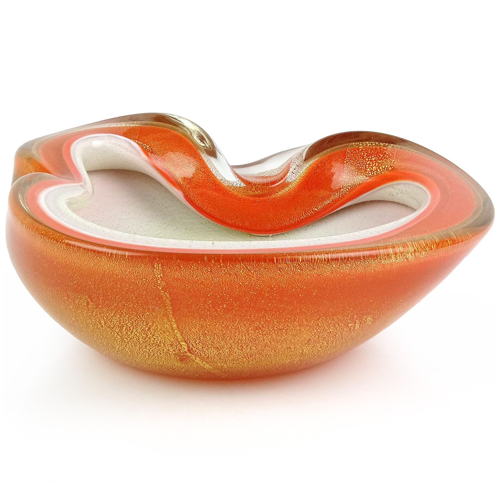Beautiful vintage Murano hand blown orange over white and gold flecks Italian art glass bowl. Documented to designer Alfredo Barbini, circa 1950-1960. Profusely covered in gold leaf inside and out. Can be used as a display piece on any table. Use it