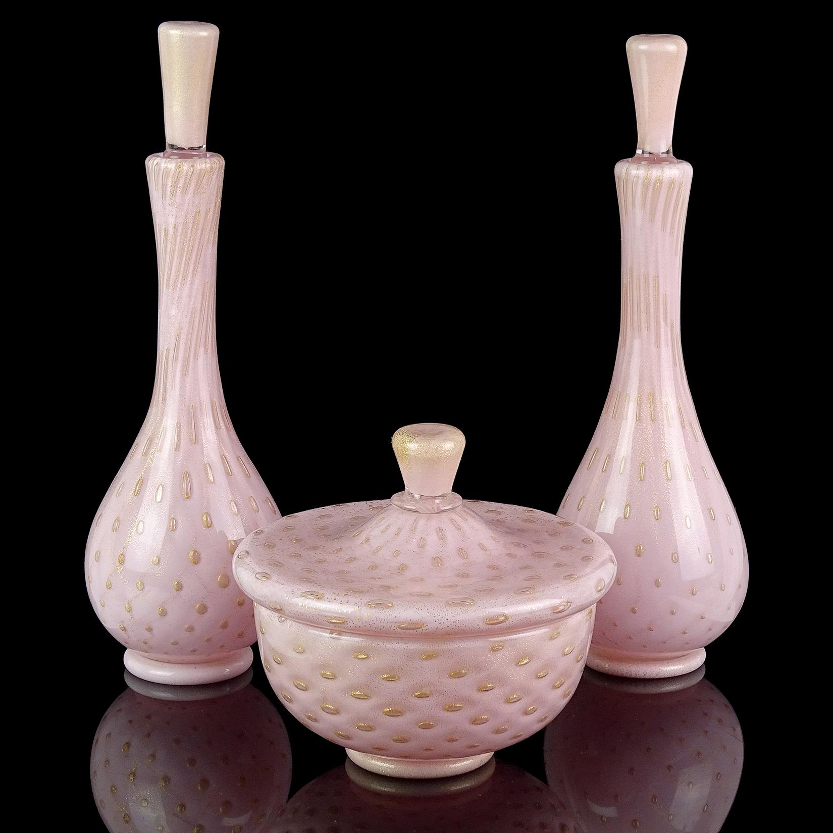 Beautiful vintage Murano hand blown pink, controlled bubbles and gold flecks Italian art glass vanity / dresser powder box with matching bottles. Documented to designer Alfredo Barbini. The gold leaf gathers around each bubble, making them really
