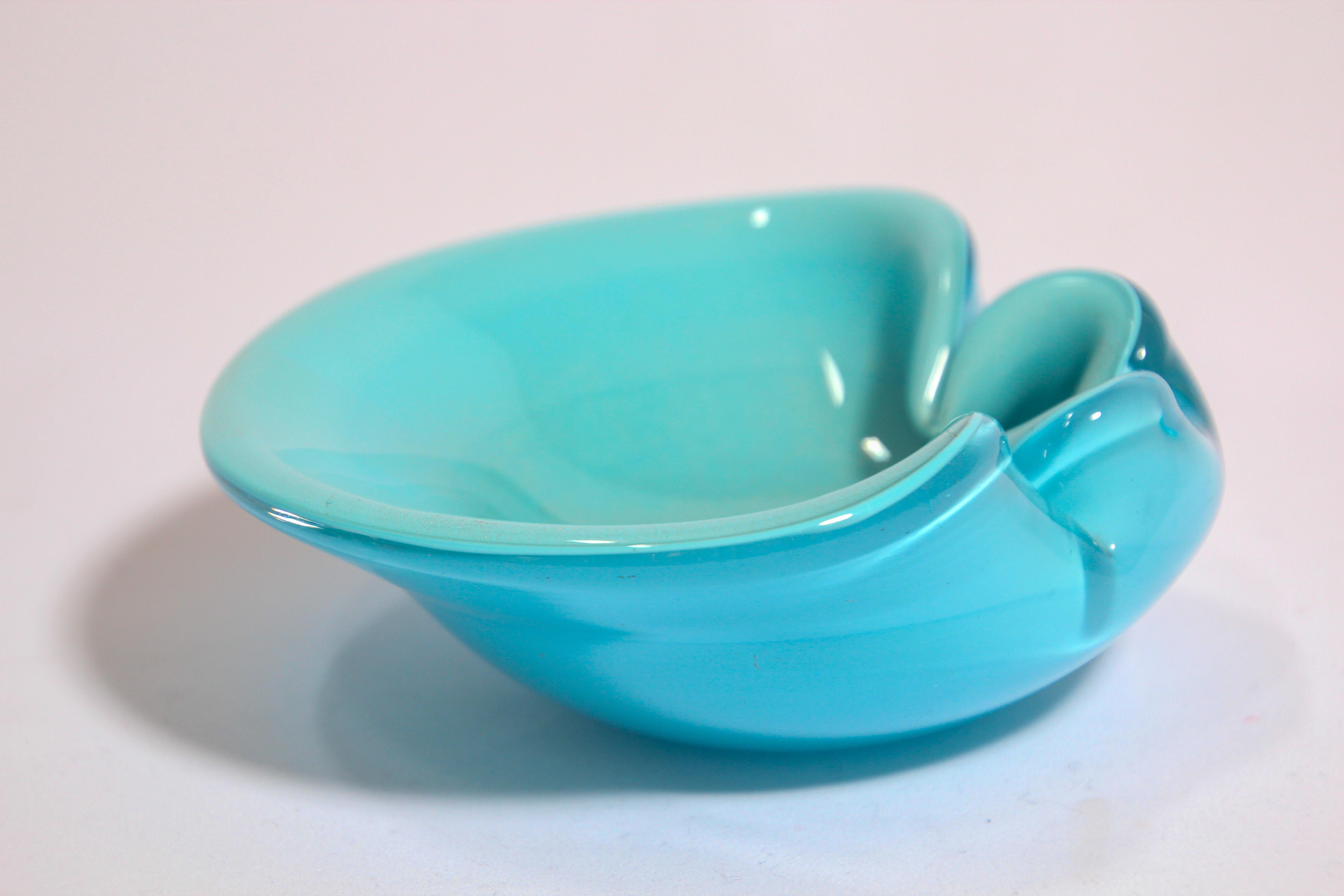 Gorgeous mid 20th-century Italian Murano Venetian handblown light blue art glass flower shaped bowl or ashtray. 
Sculptural organic open flower form in turquoise and beautiful gold flecks decoration in aventurine technique.
The catchall bowl has