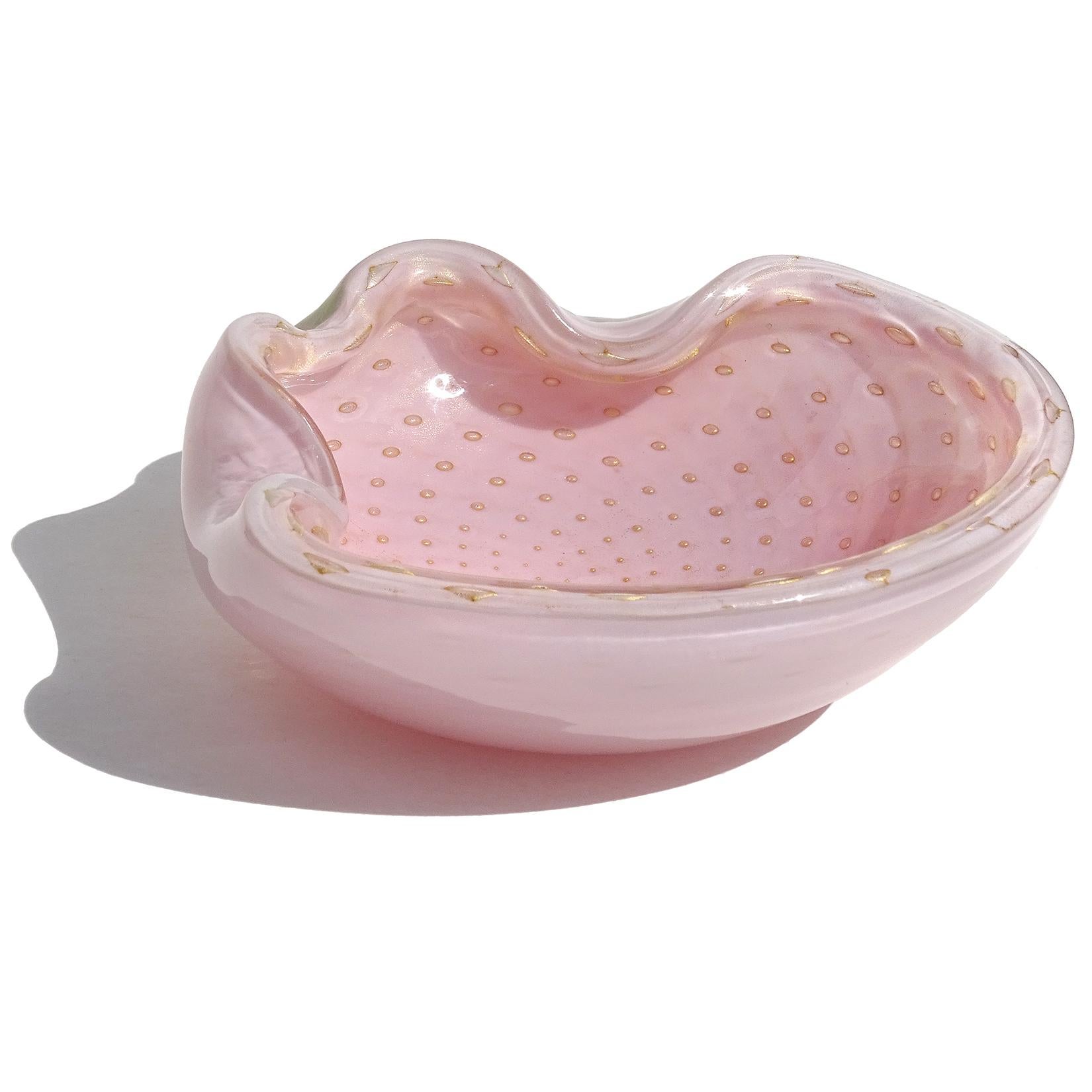Beautiful vintage Murano hand blown pink, controlled bubbles, and gold flecks Italian art glass decorative bowl / ashtray. Documented to designer Alfredo Barbini, circa 1950s. Profusely covered in gold leaf, with the gold clinging to each of the