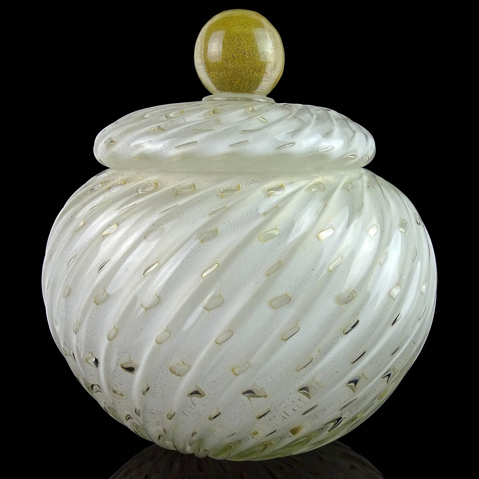 Beautiful Murano hand blown white, controlled bubbles and gold flecks Italian art glass cookie jar / container. Documented to designer Alfredo Barbini, circa 1950s. The piece is large and heavy, with a ribbed pattern and gold ball top decoration.