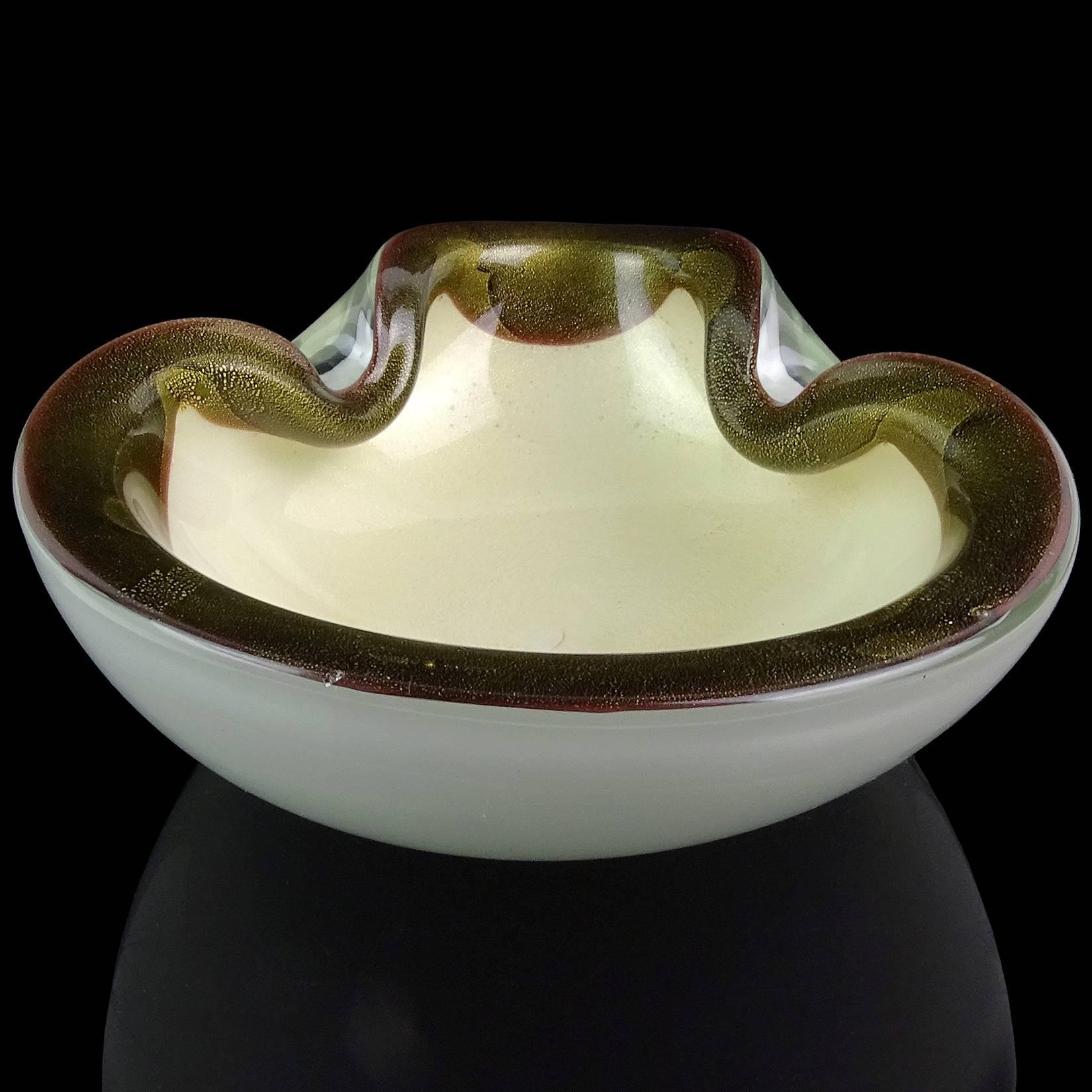 Beautiful vintage Murano hand blown white and gold flecks Italian art glass bowl with black decoration around the rim. Documented to designer Alfredo Barbini. The piece is profusely covered in gold leaf. Would make a great display piece on any