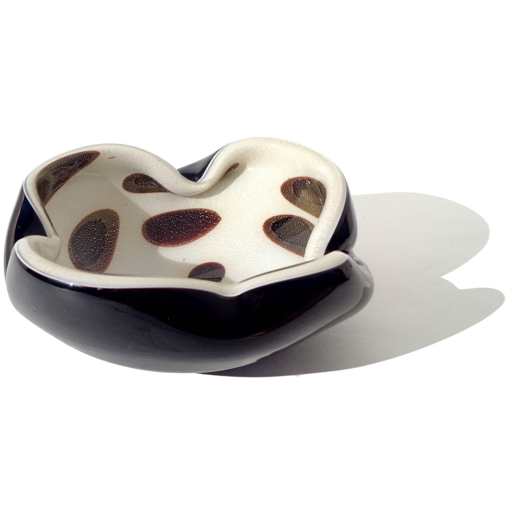 Beautiful vintage Murano hand blown black over white and gold flecks Italian art glass bowl with spots decoration. Documented to designer Alfredo Barbini. The bowl is profusely covered in gold leaf. Can be used as a display piece on any table. Use