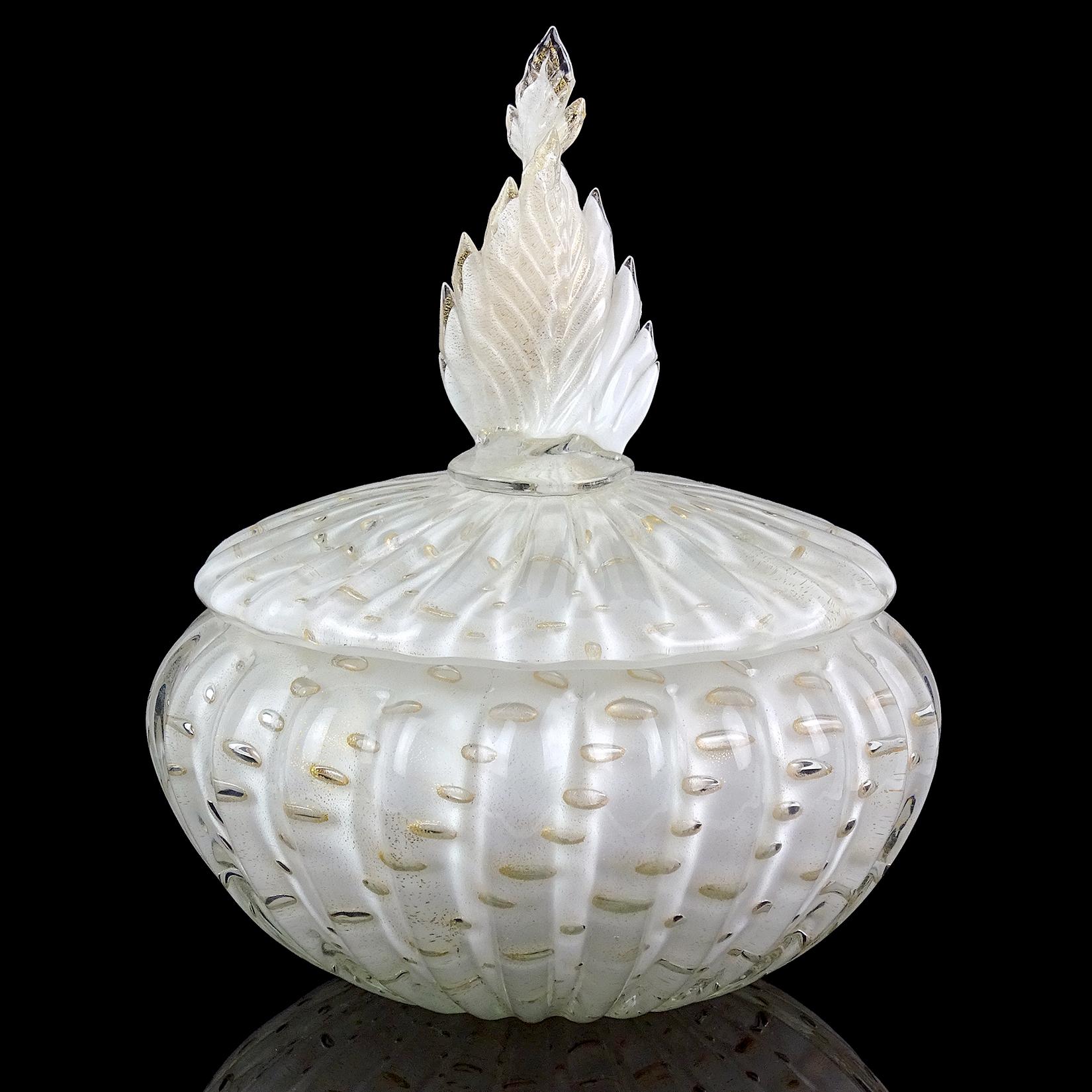 Beautiful vintage Murano hand blown white, controlled bubbles and gold flecks Italian art glass vanity powder or jewelry box. Documented to designer Alfredo Barbini, circa 1950s. The lidded jar has a ribbed body with twisting leaf on the top. The