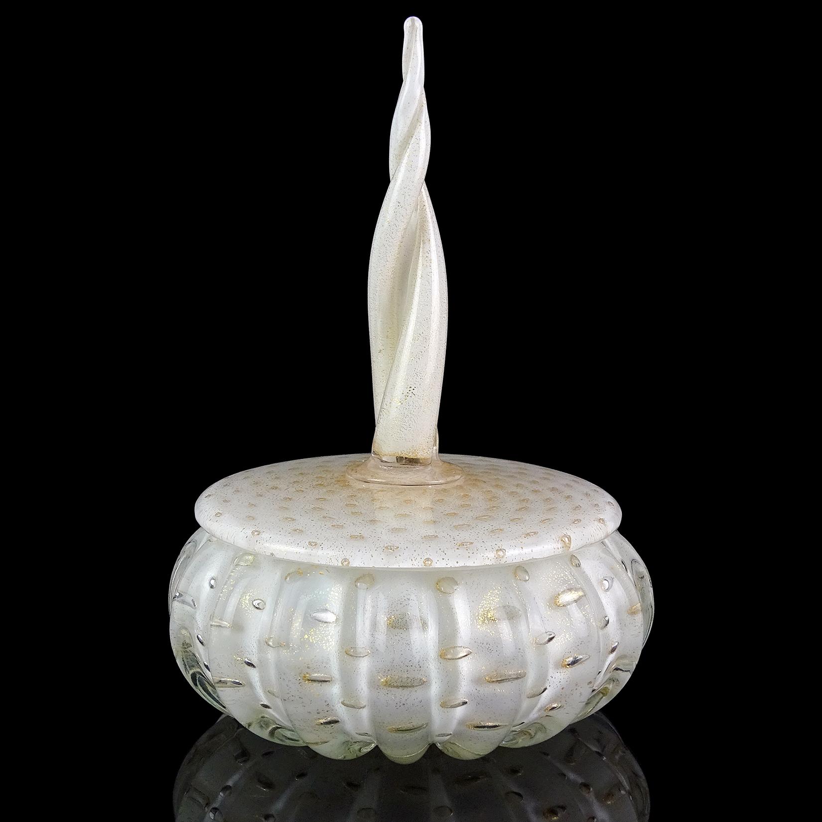 Beautiful vintage Murano hand blown white, controlled bubbles and gold flecks Italian art glass vanity powder or jewelry box. Documented to designer Alfredo Barbini, circa 1950s. The lidded jar has a ribbed body with twisting spike on the top. The