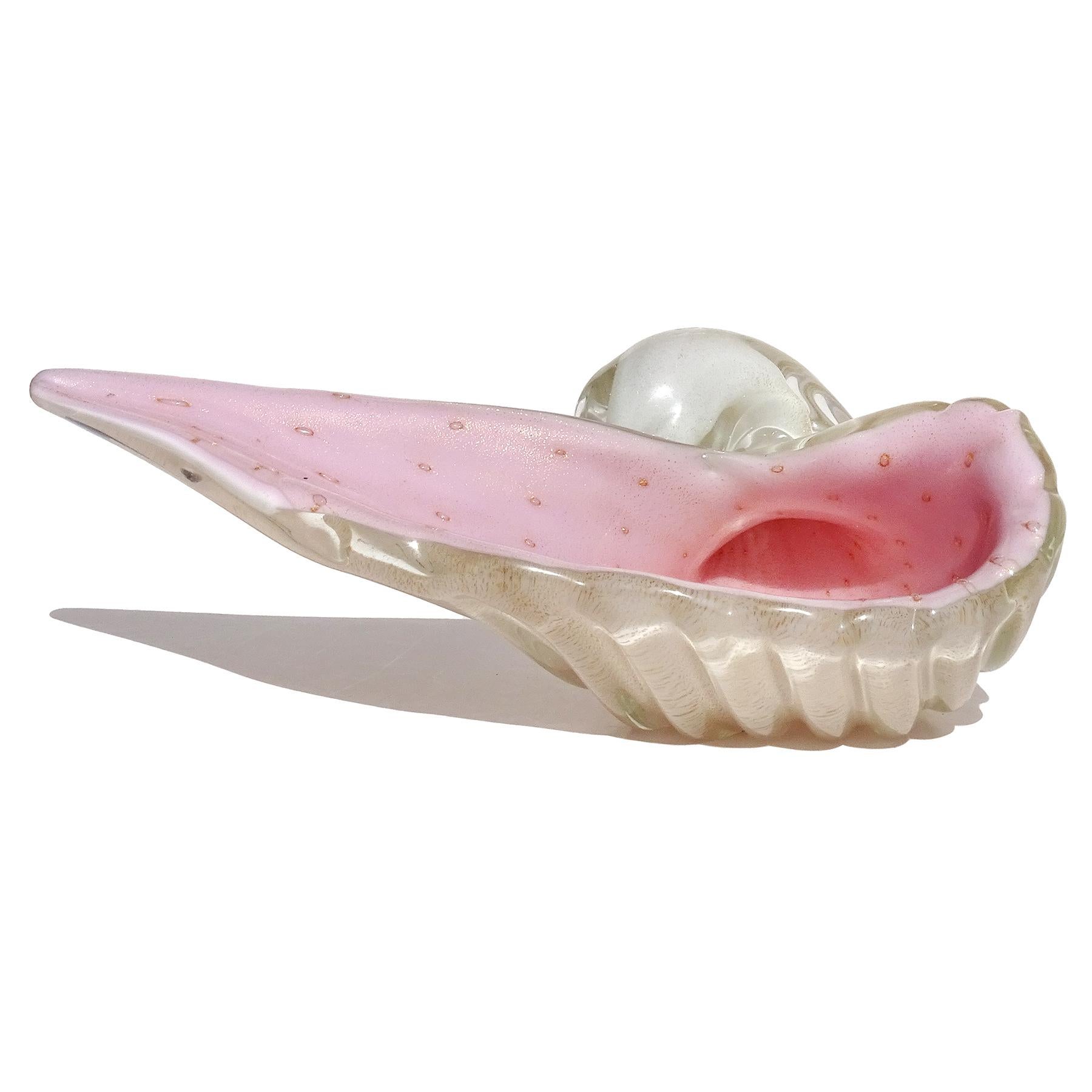 Beautiful vintage Murano hand blown pink, white, gold flecks and controlled bubbles Italian art glass sculptural seashell bowl. Documented to designer Alfredo Barbini. The piece has a white outer layer that is covered in gold leaf, with the inside