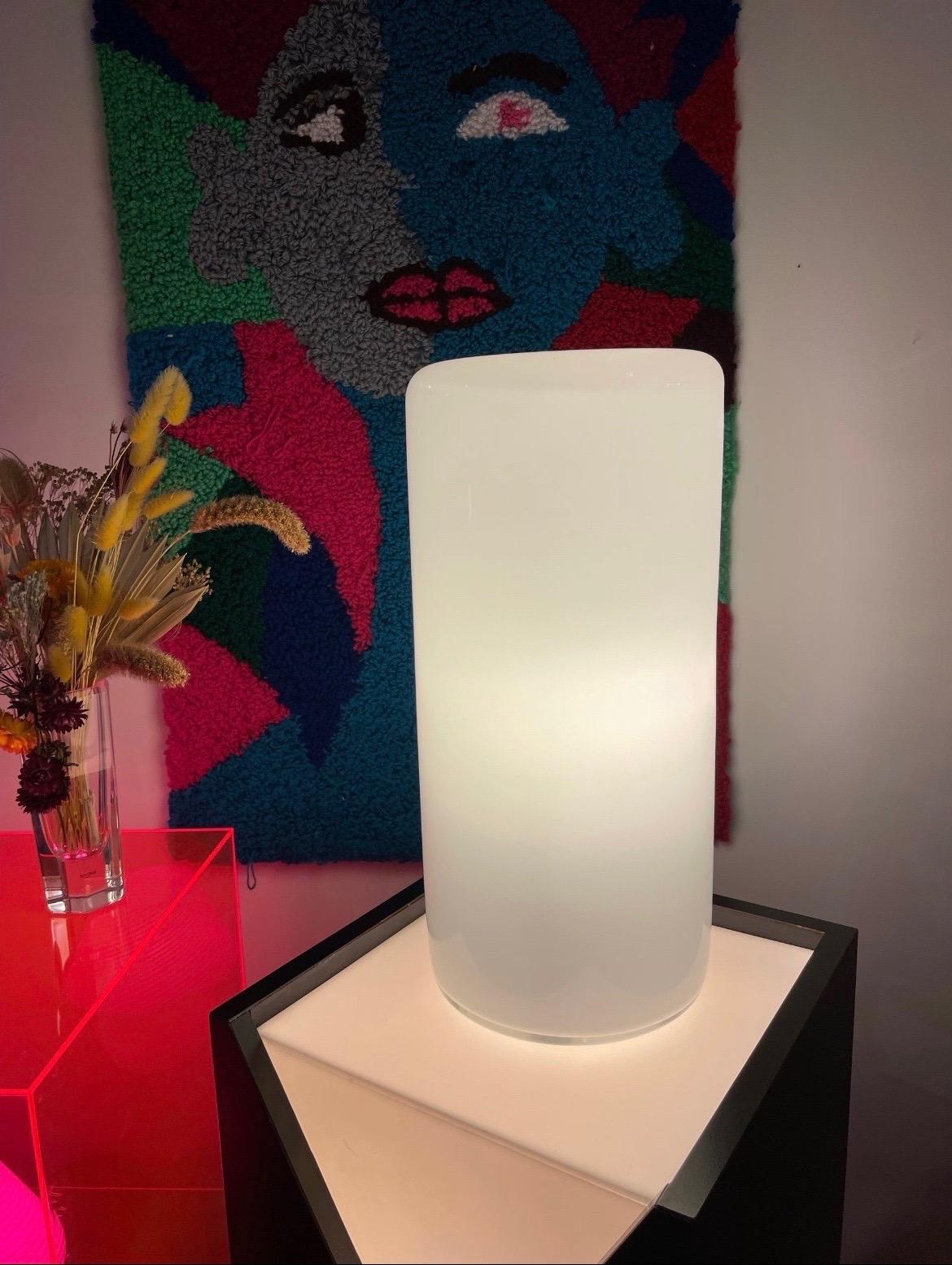 Simply stunning 80’s murano lamp by master glassworker Alfredo Barbini. Masterfully cylindrical body of white opaline glass is bordered with transparent glass; the imperfect top reminds us this beauty is handmade. In excellent condition. Newly